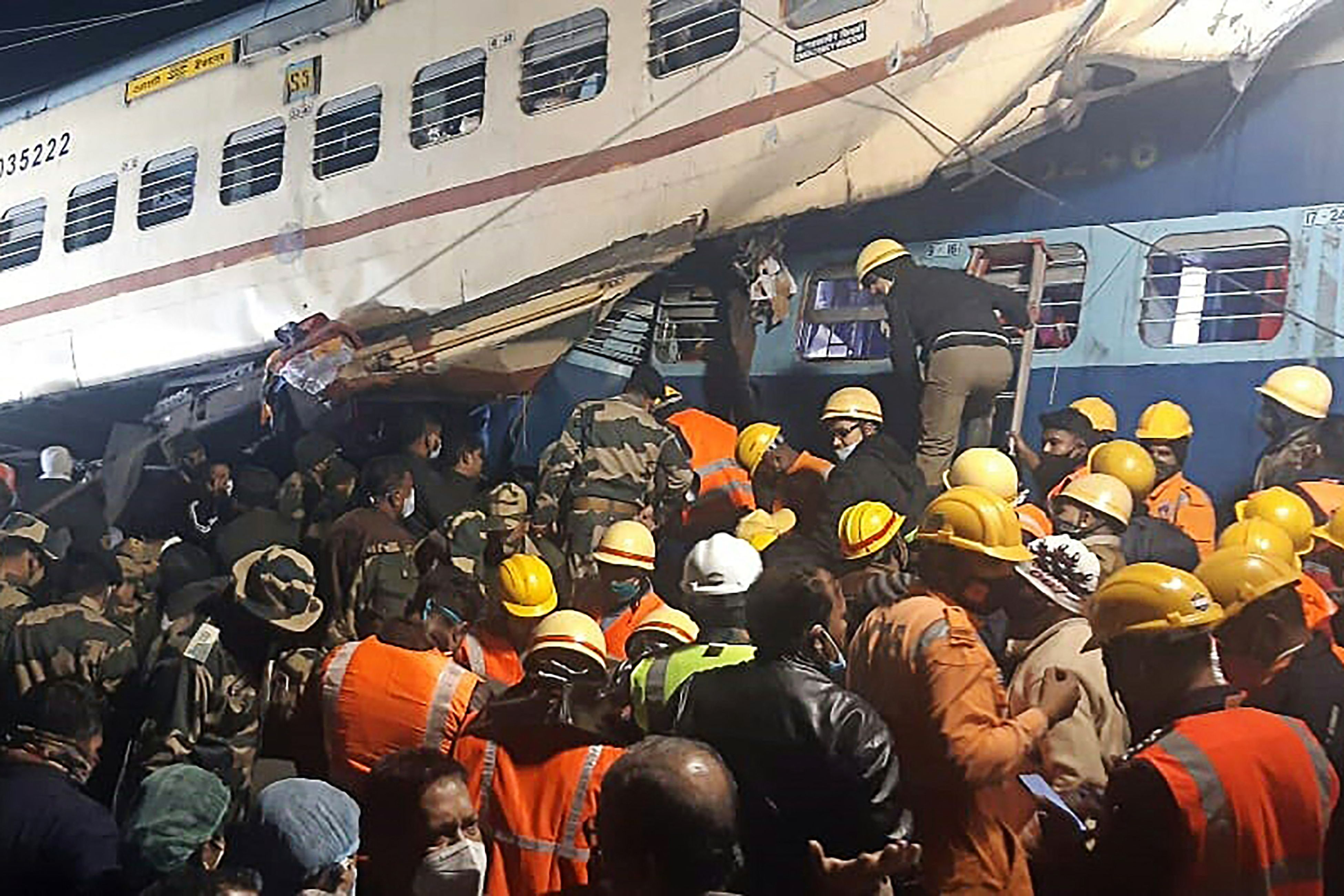 Disaster management and rescue teams work at the site of a train accident near Maynaguri railway station in the eastern Indian state of West Bengal on 13 January 2022