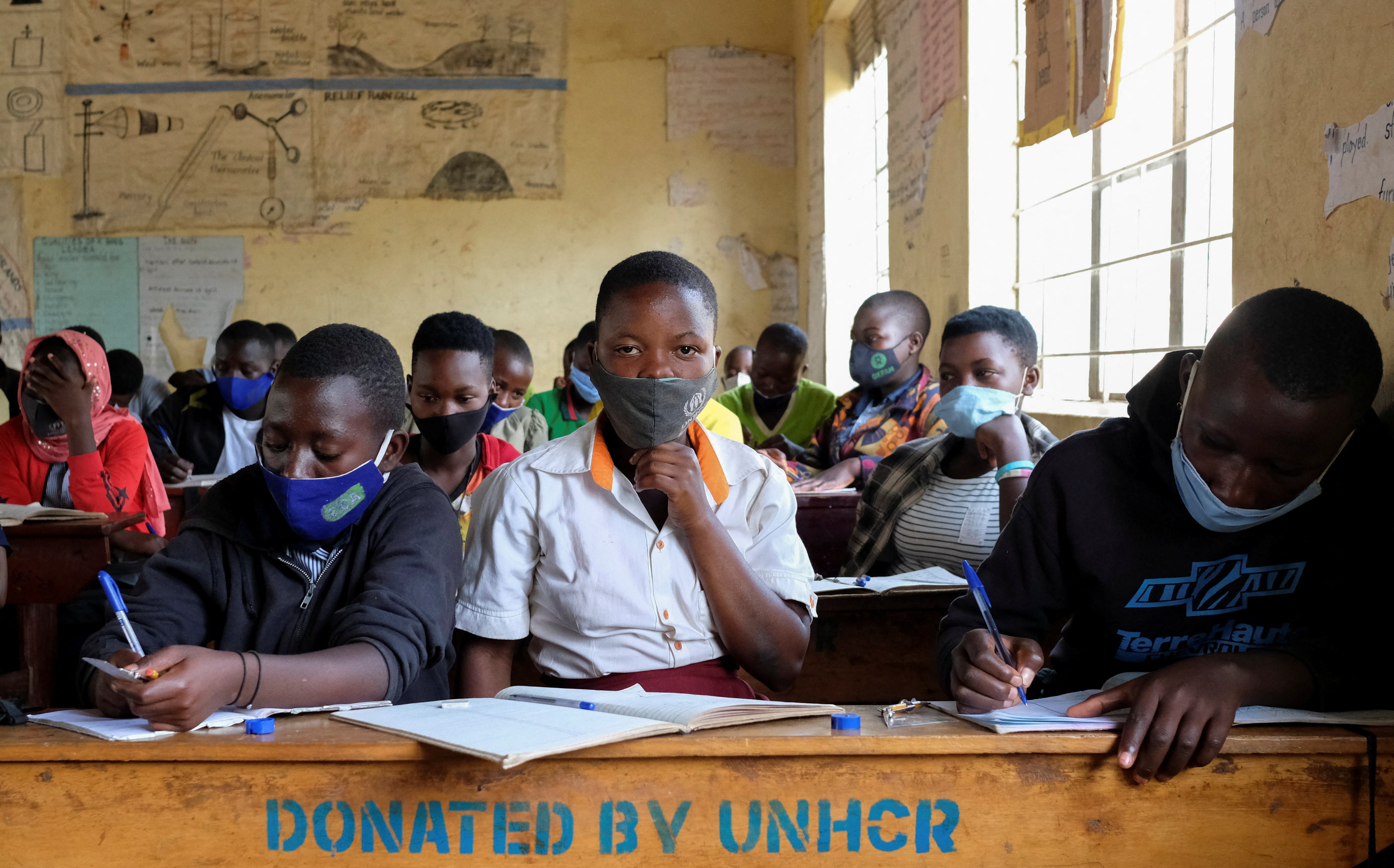 Pupils sit inside their classroom at the Sweswe primary school in Kyegegwa District, Uganda