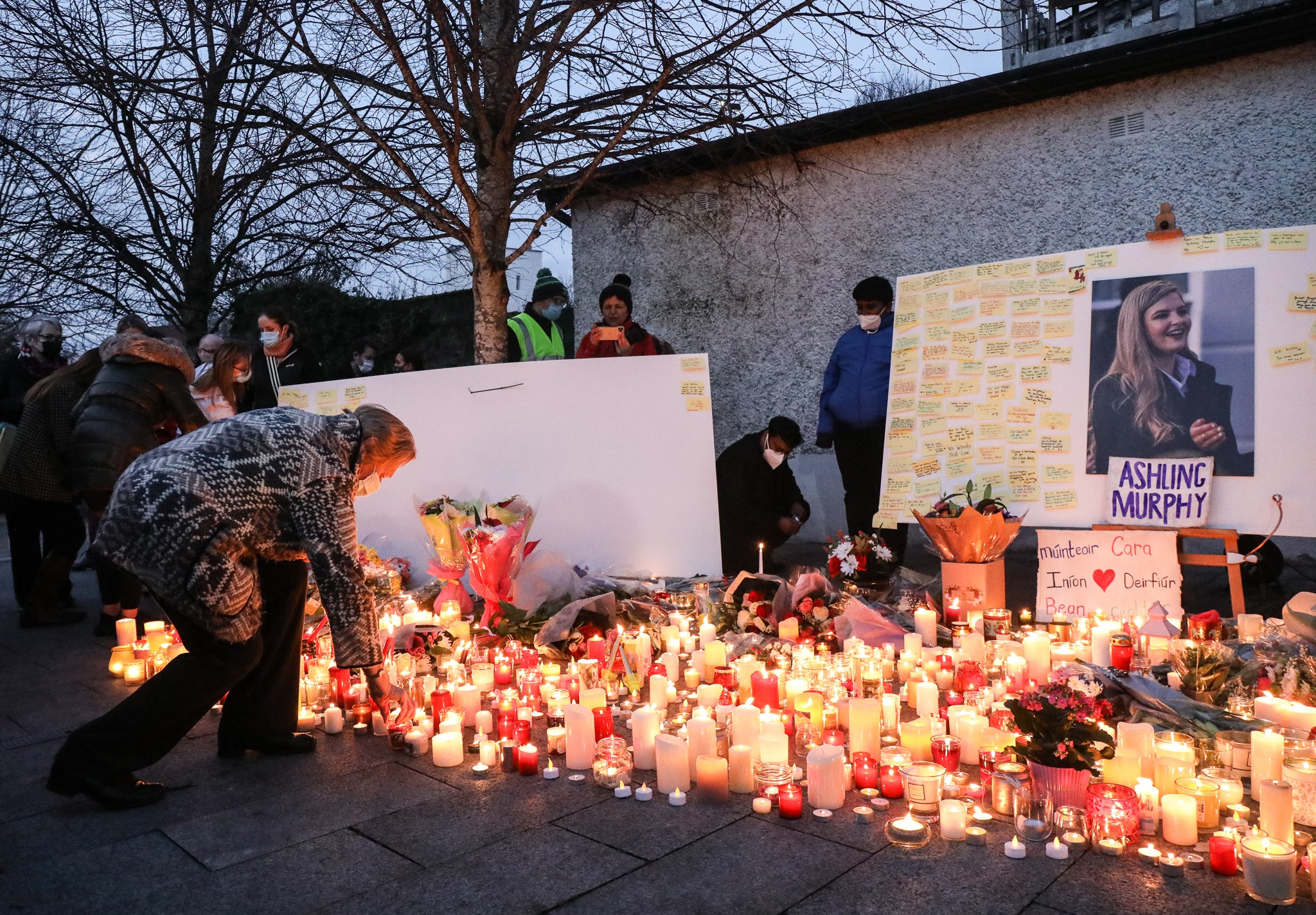 Mourners light candles after a vigil in memory of Aisling Murphy