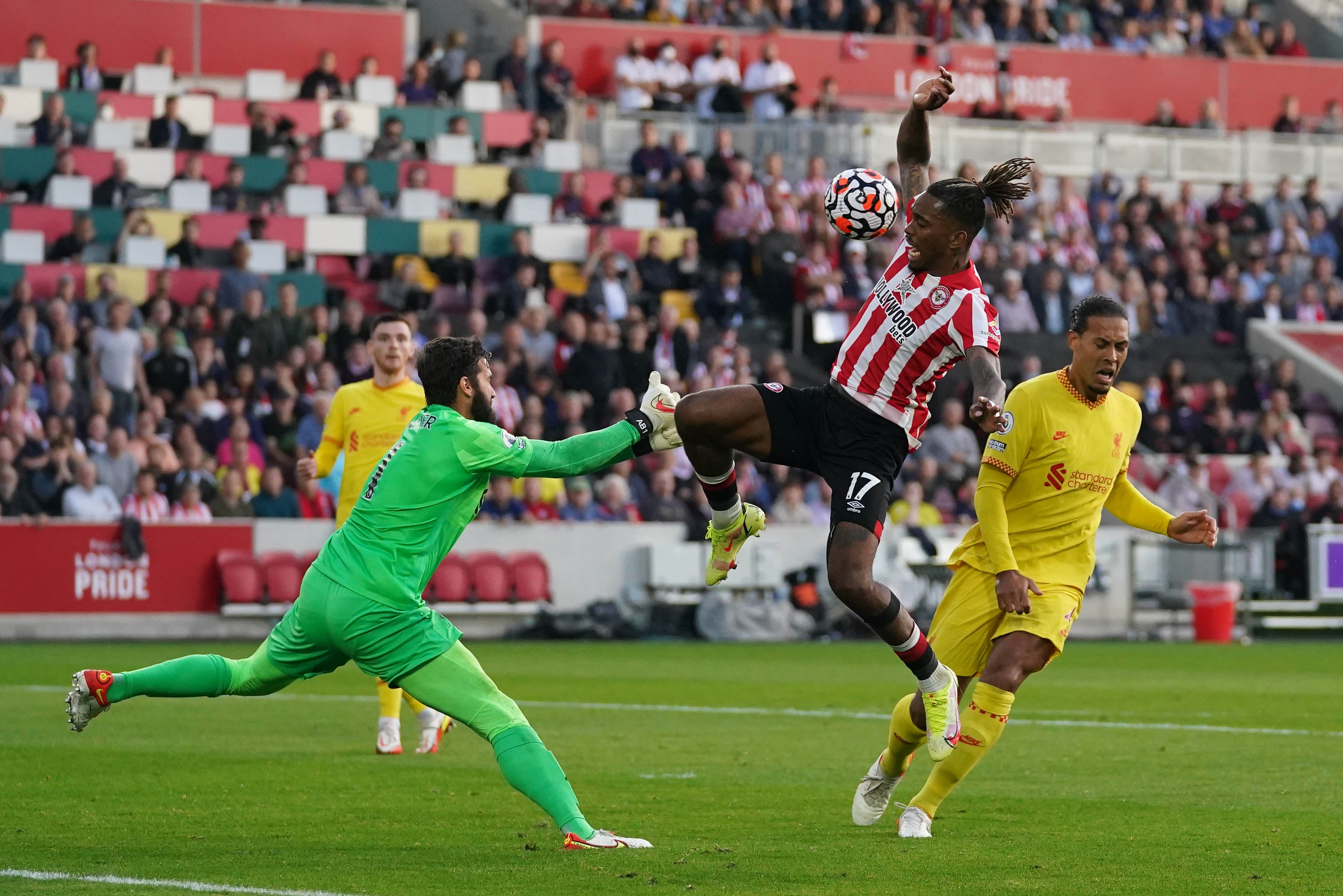 Liverpool goalkeeper Alisson and Virgil Van Dijk combine to stop Brentford’s Ivan Toney from scoring (Adam Davy/PA)