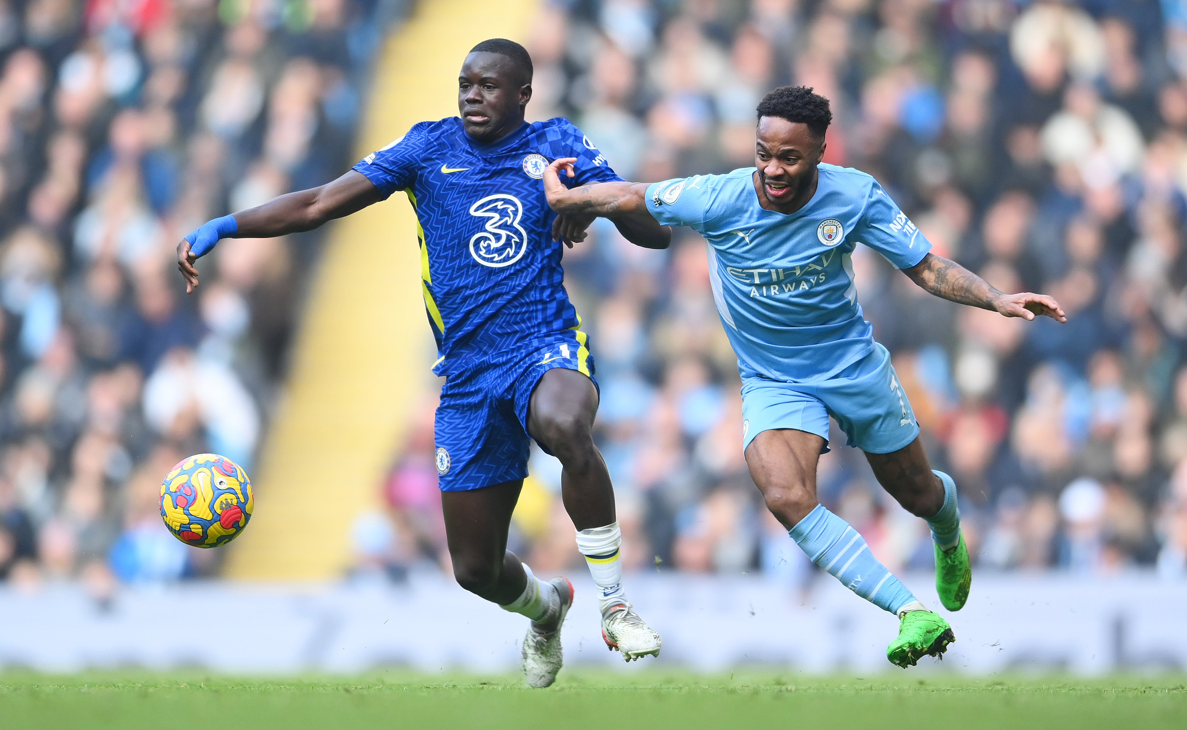 Raheem Sterling battles for the ball