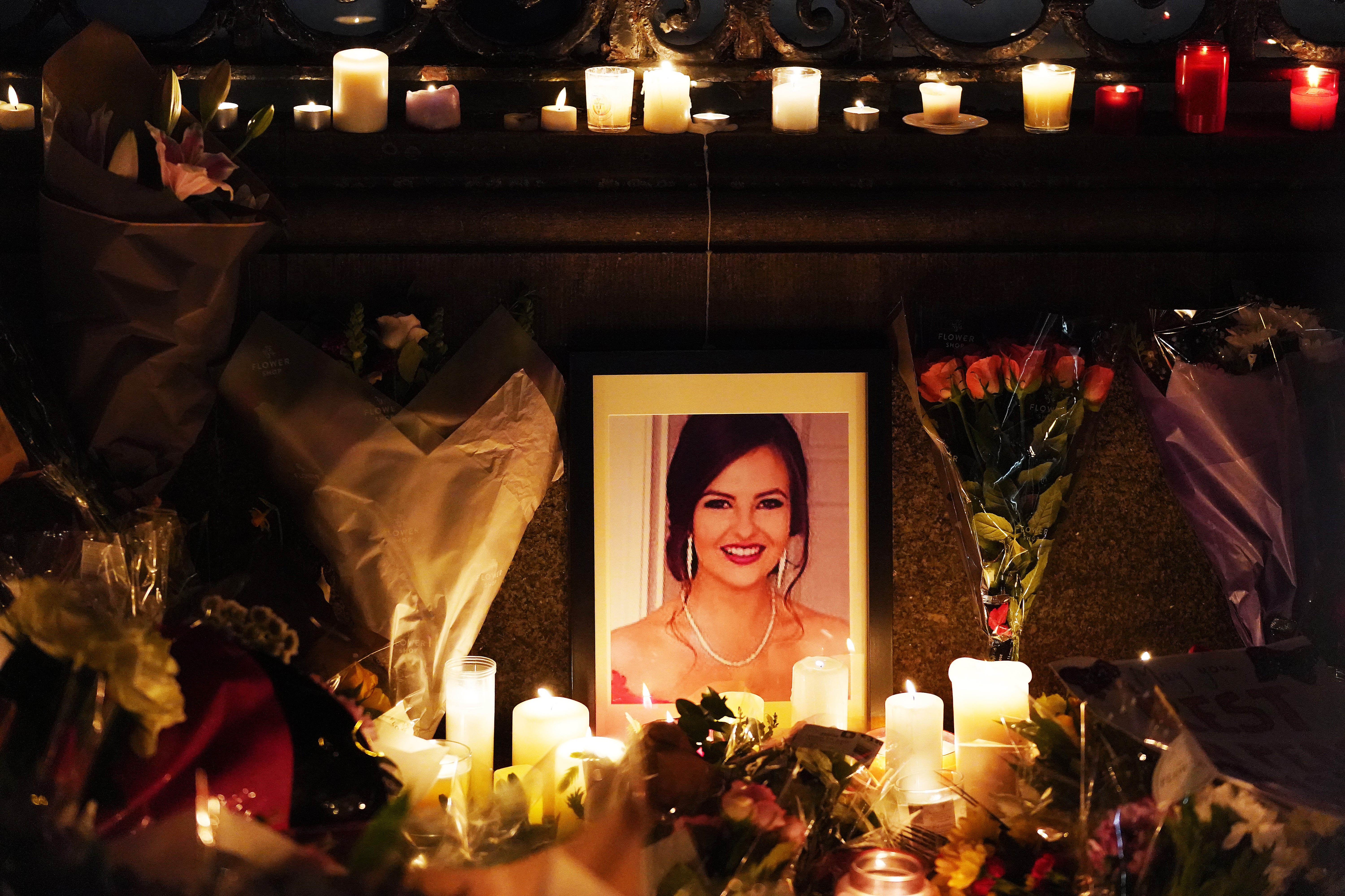 A photograph of Ashling Murphy among flowers and candles during a vigil in her memory at Leinster House, Dublin (Brian Lawless/PA)