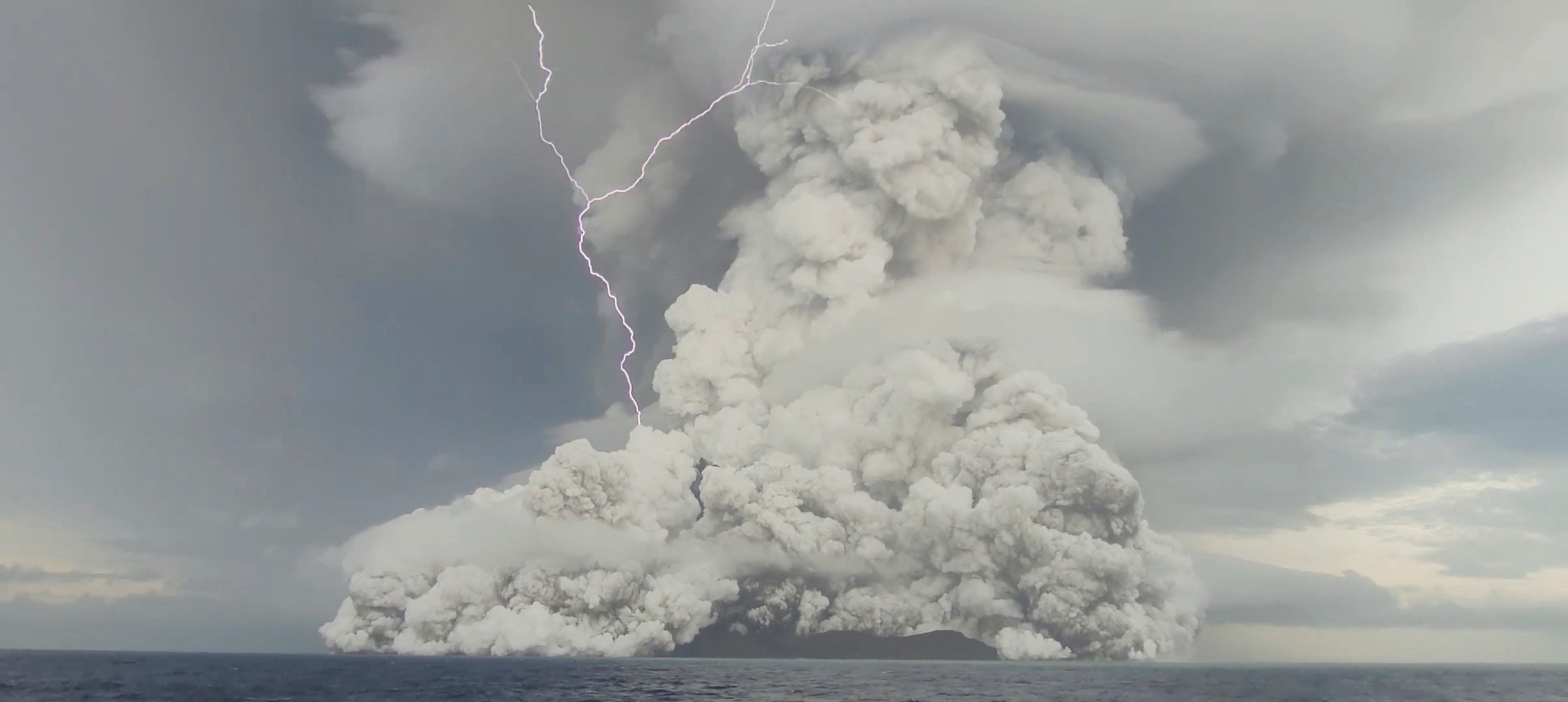 The eruption at the underwater volcano Hunga Tonga-Hunga Ha’apai off Tonga is captured in this screen grab obtained from a social media video