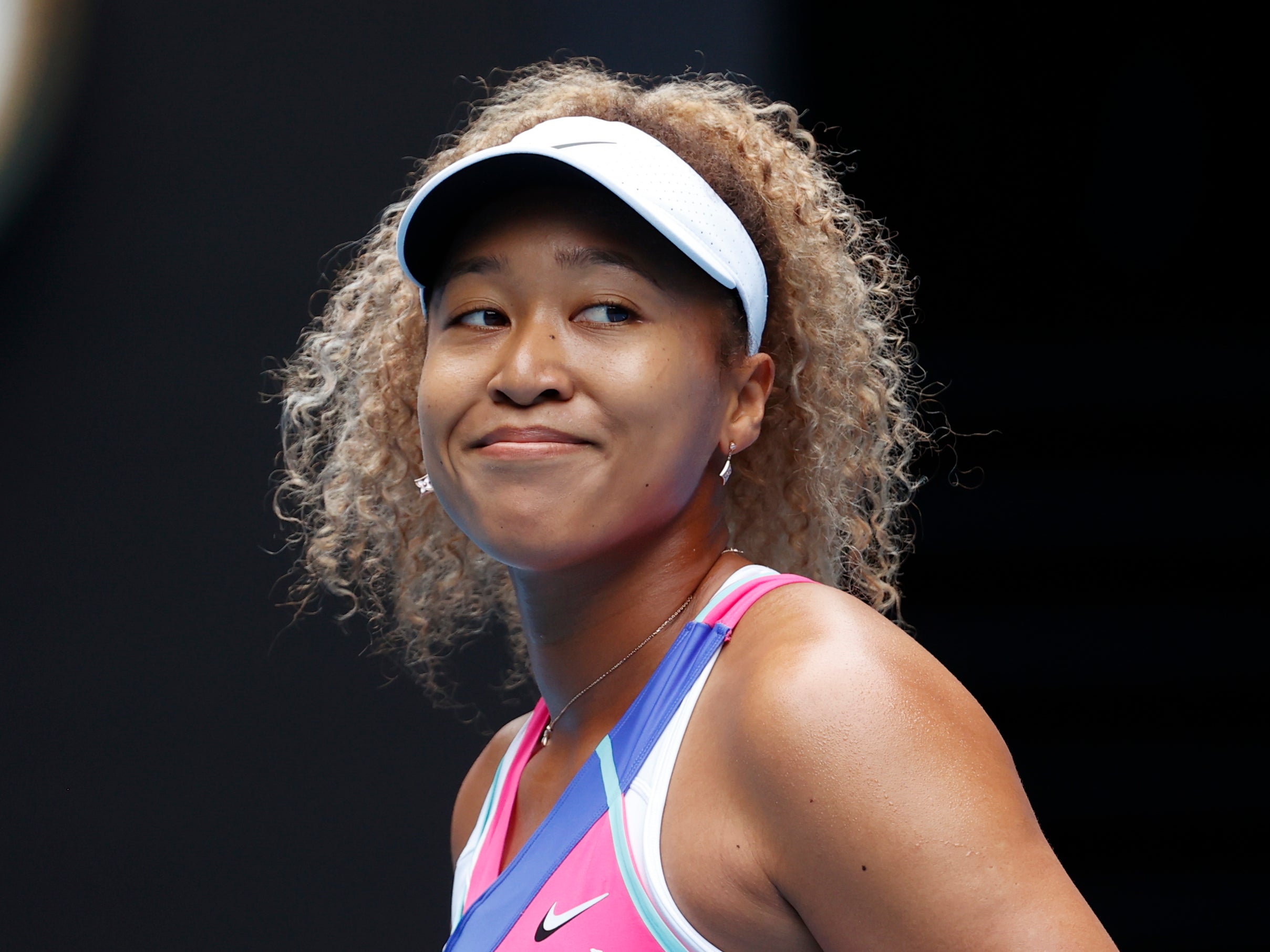 Naomi Osaka smiles on her return to the Australian Open (Simon Baker/AP)