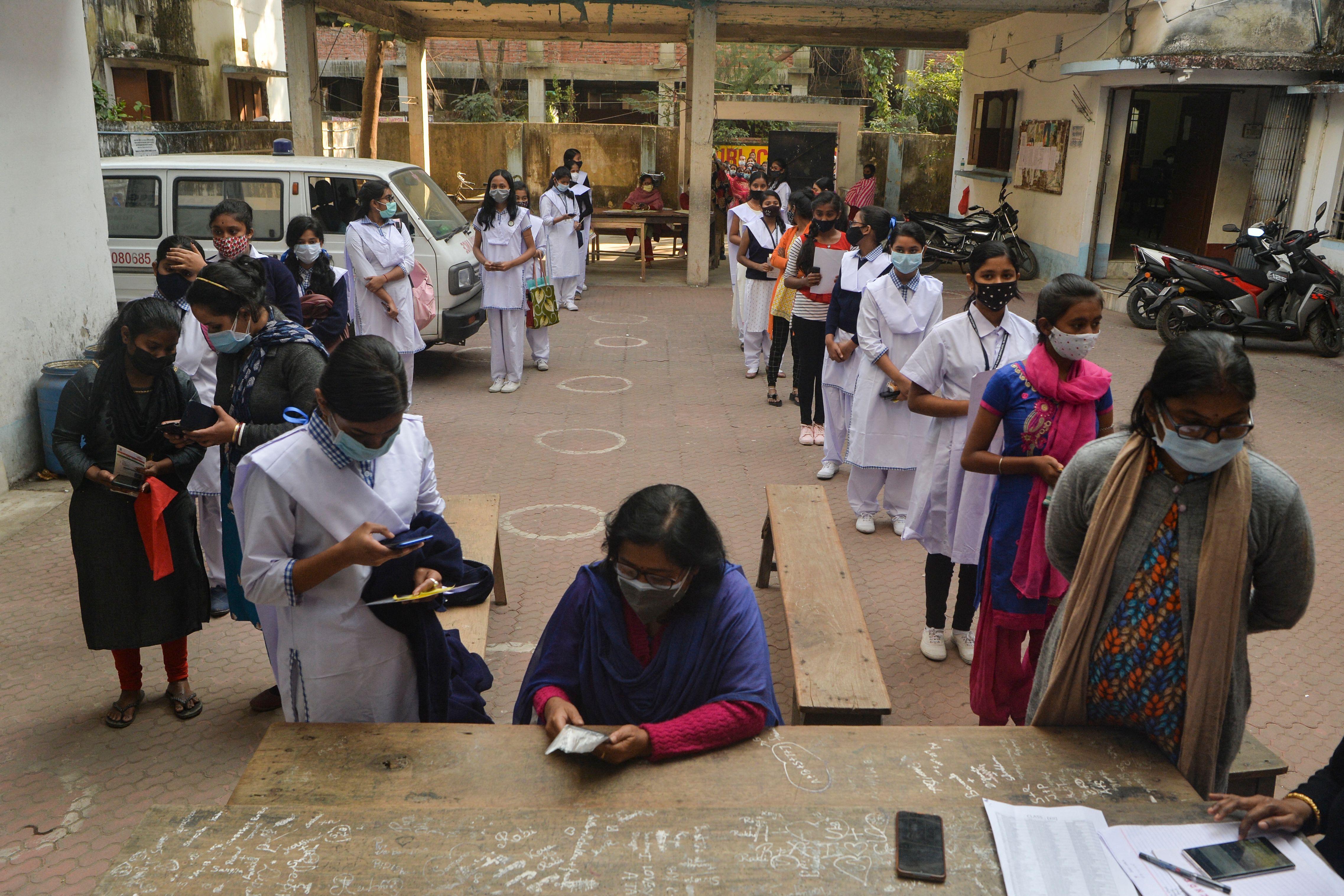 Students queue up to register themselves for the coronavirus vaccine at Siliguri Hakimpara Girls school in Siliguri on 8 January 2022