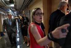 Washington, the White House and a warming world wait for Kyrsten Sinema