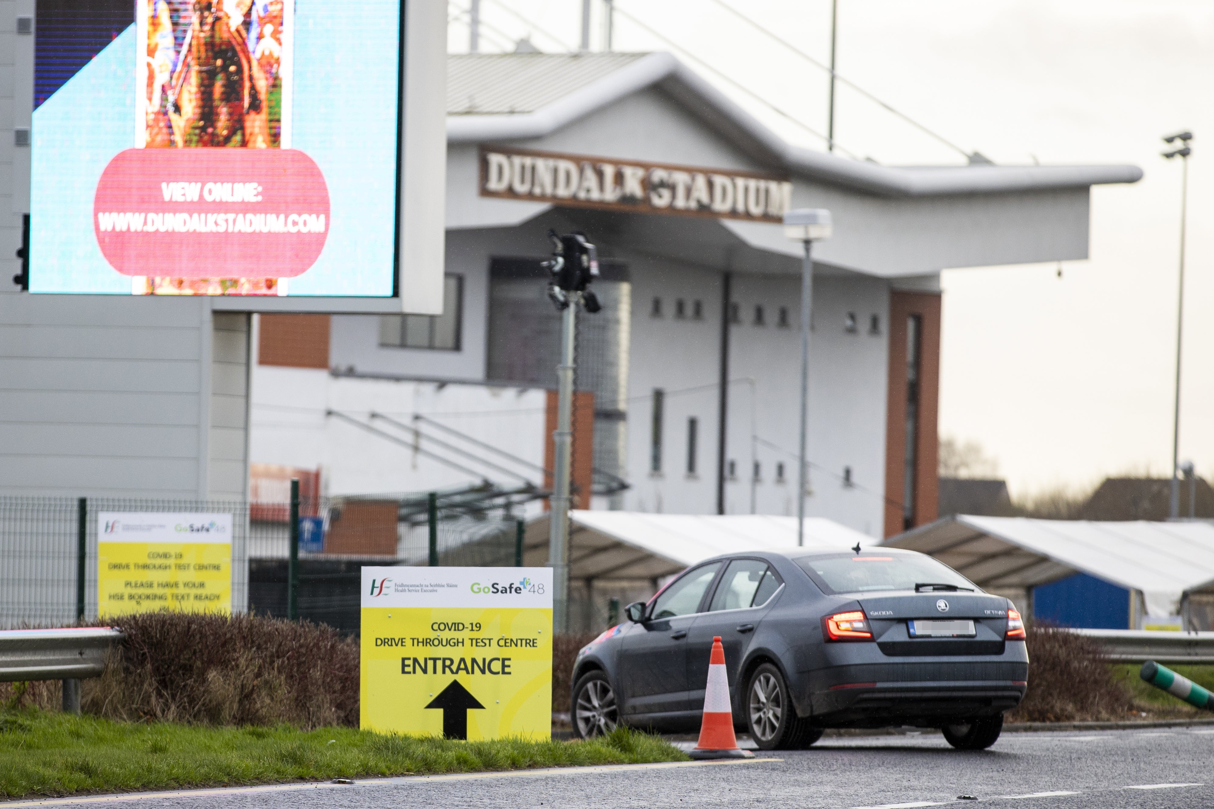 A car arrives to Dundalk Stadium Covid-19 drive through test centre (Liam McBurney/PA)