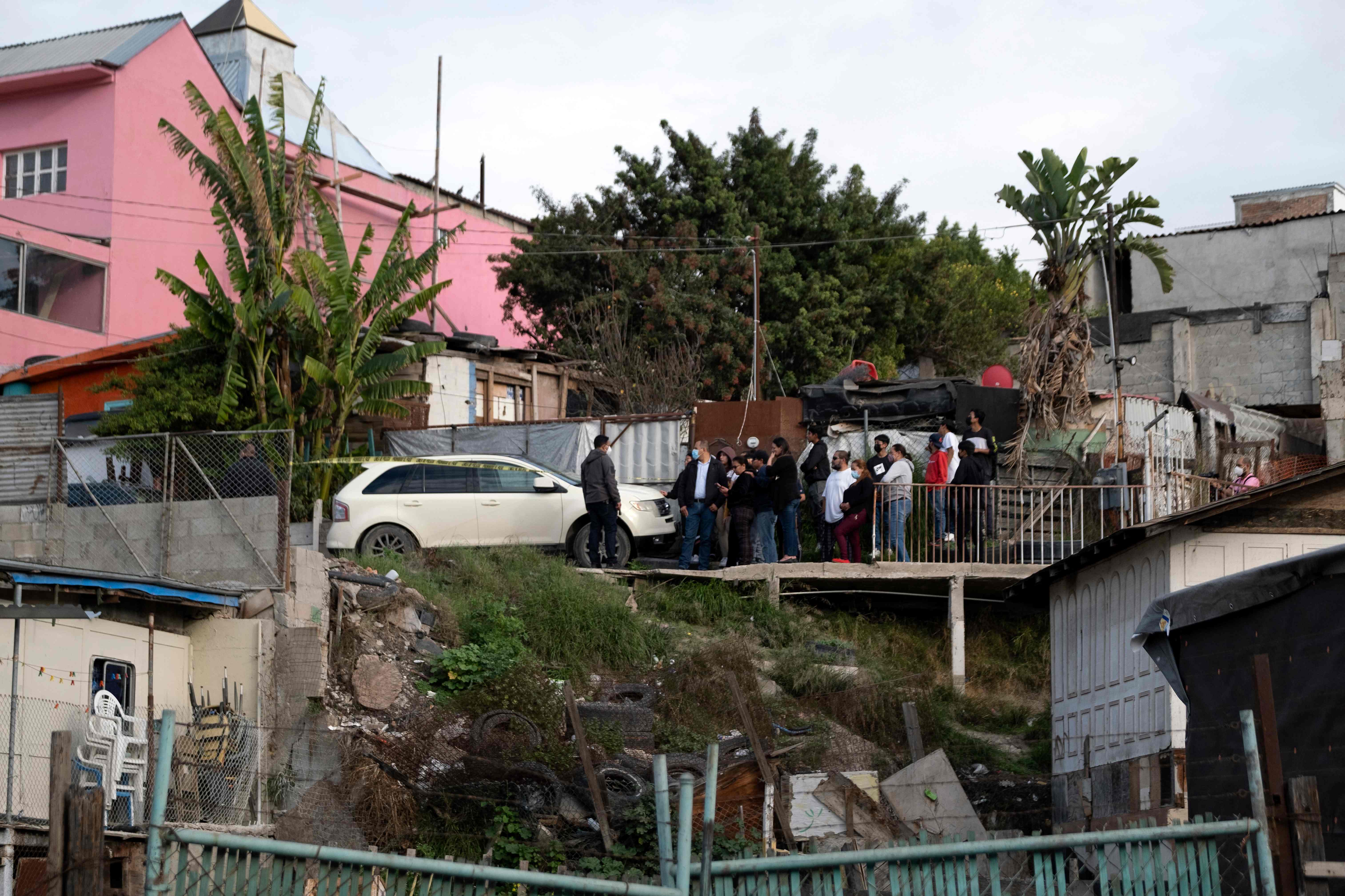 Relatives and friends of Mexican photojournalist Margarito Martinez gather at the site where he was shot dead