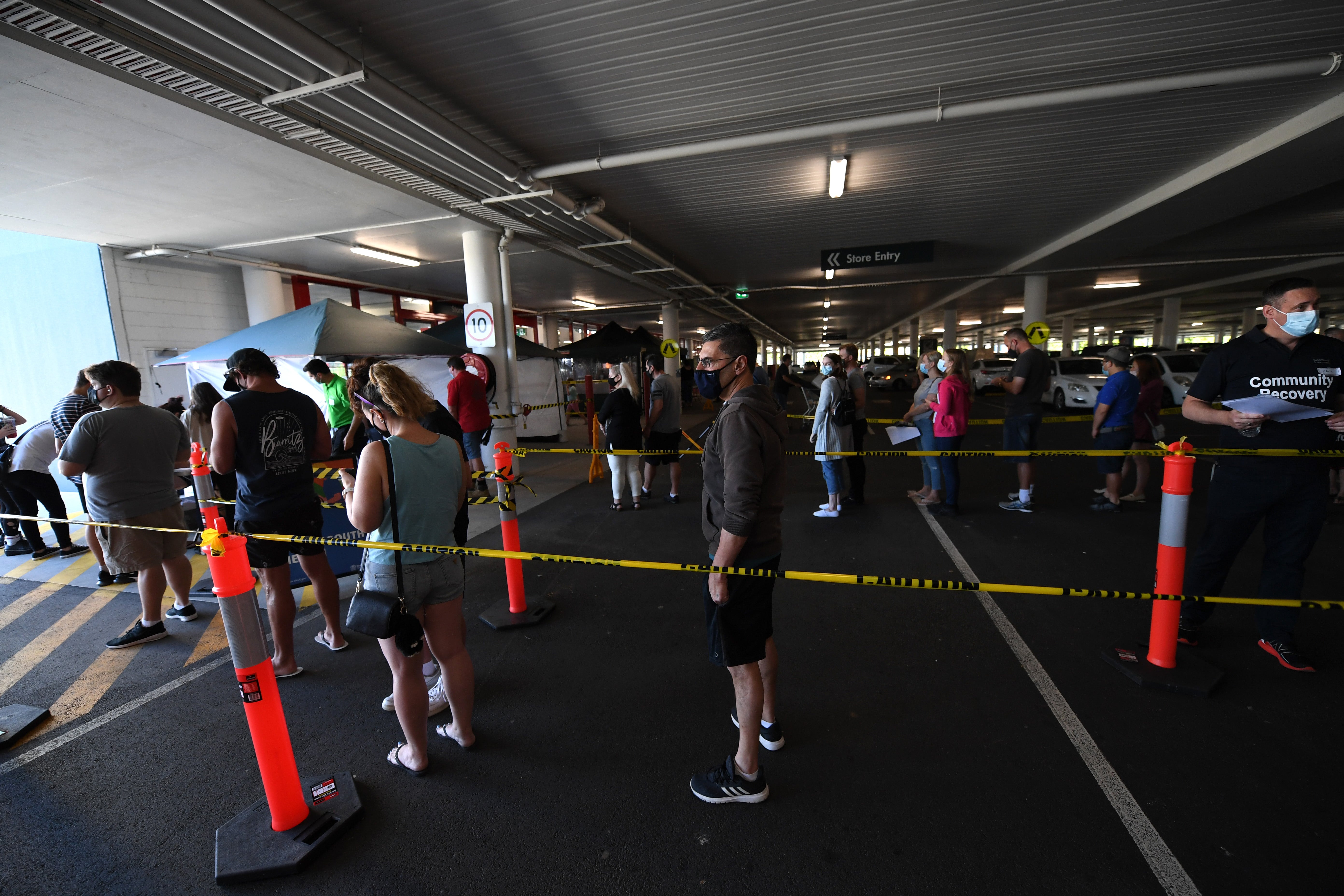 People line up to receive a Covid-19 vaccine at a Bunnings hardware store on 16 October in Brisbane, Australia