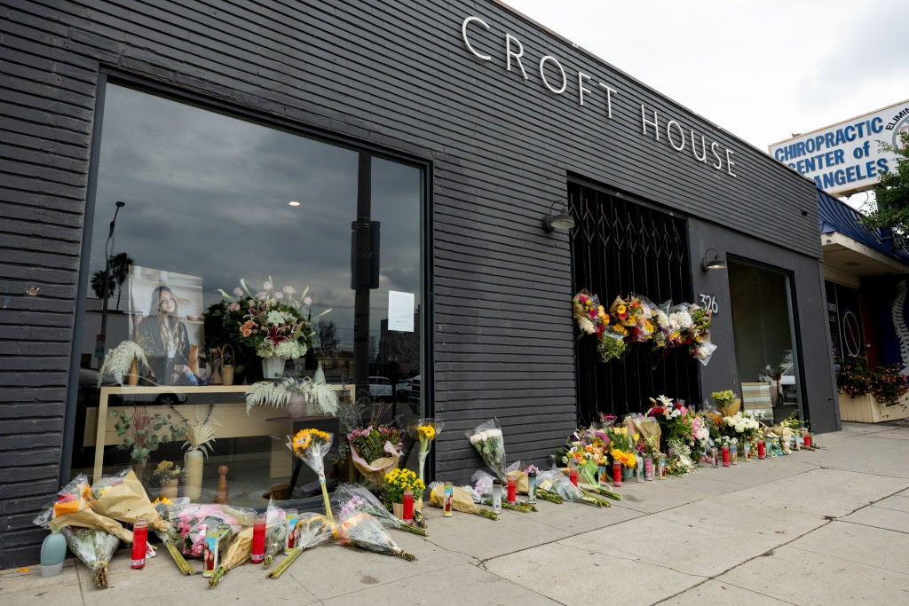 Flowers are placed outside Croft House furniture store in memory of graduate student Brianna Kupfer