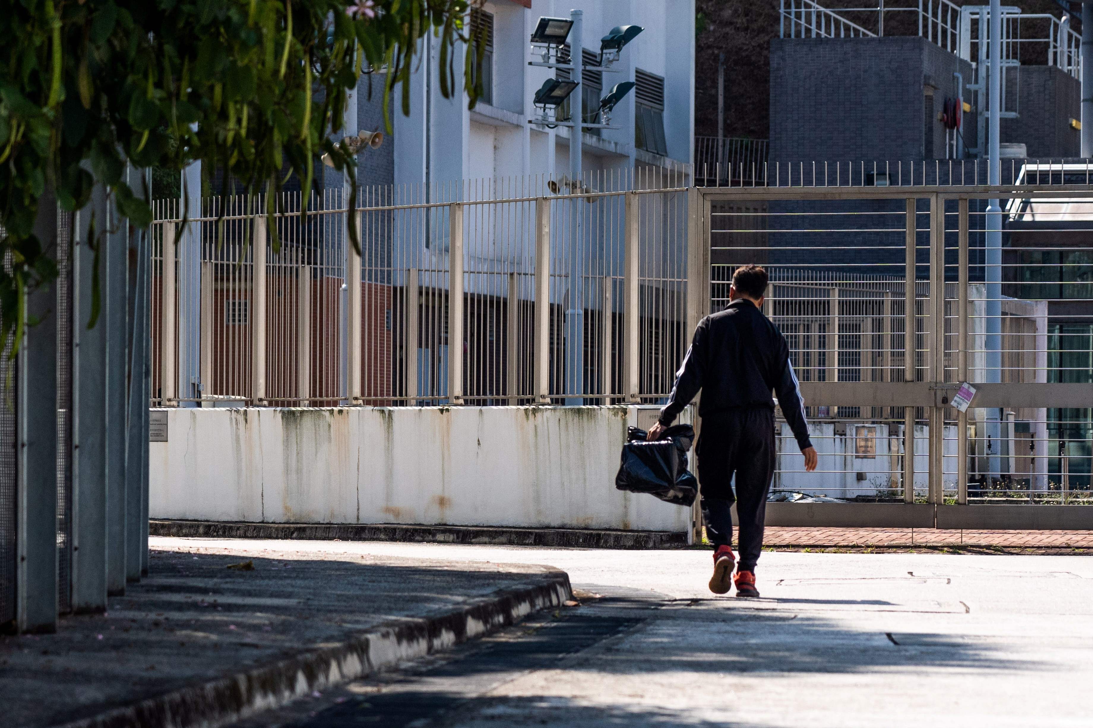 A man carries a cage containing his hamster into the New Territories South Animal Management Centre in the Shatin area of Hong Kong on 19 January after pet owners were told to give up the animals