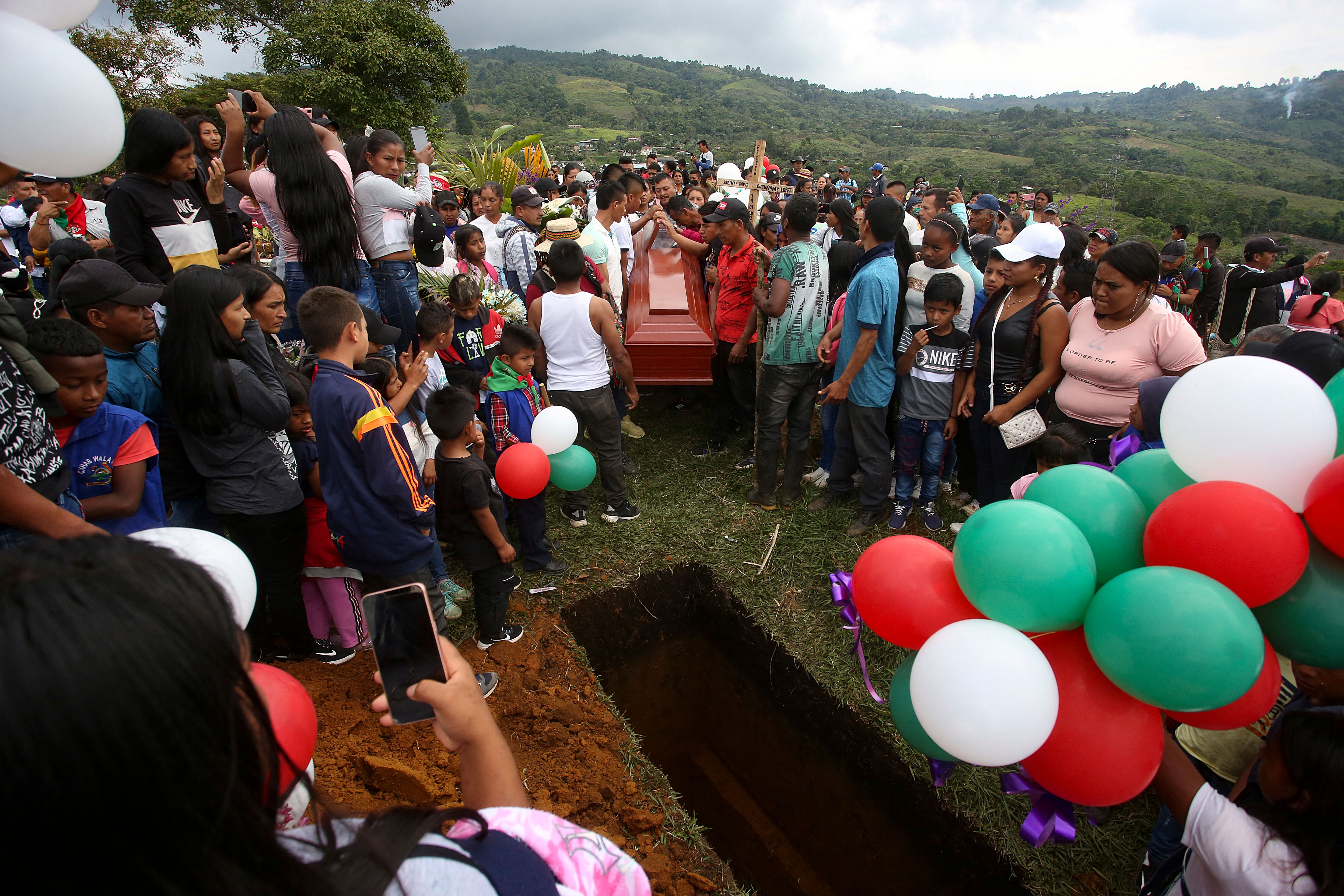 People attend the burial of Colombian 14-year-old environmental activist Breiner David Cucuname, who was shot dead during a rural security patrol on 14 January 2022