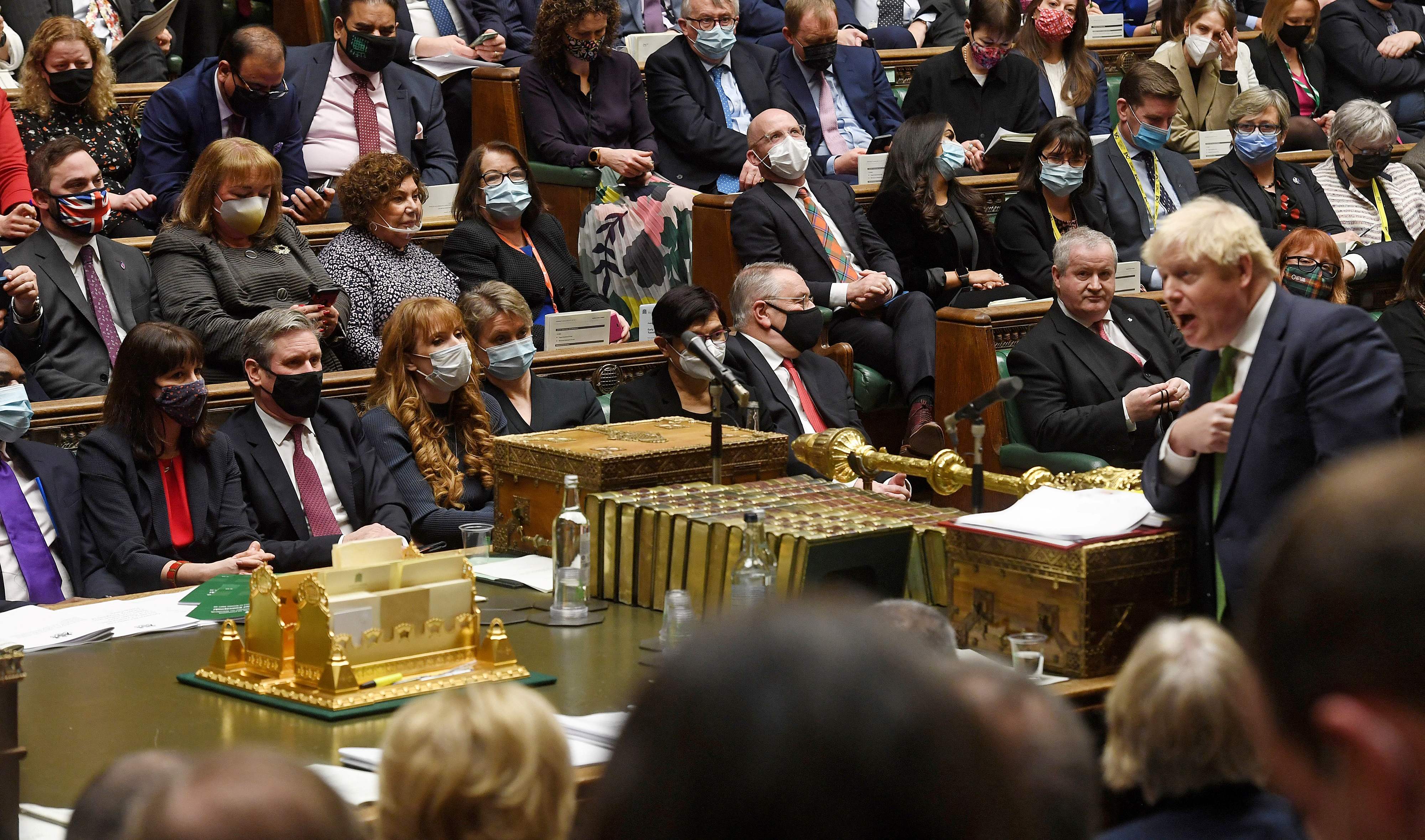 Tory defector Christian Wakeford sits behind the Labour leader, Keir Starmer, left, as Boris Johnson speaks during PMQs