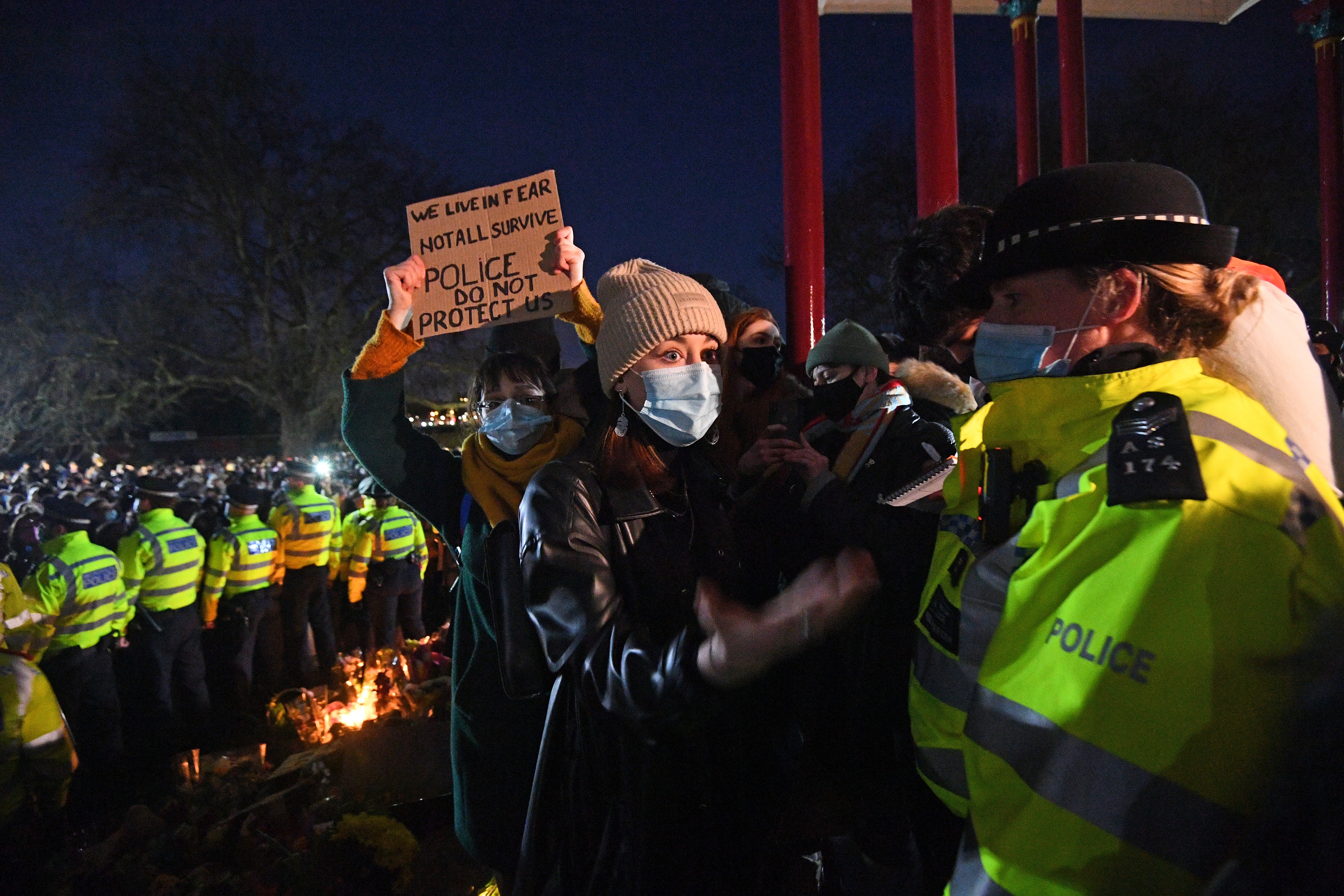 A woman holds up a placard during the vigil for Sarah Everard at Clapham Common (Victoria Jones/PA)