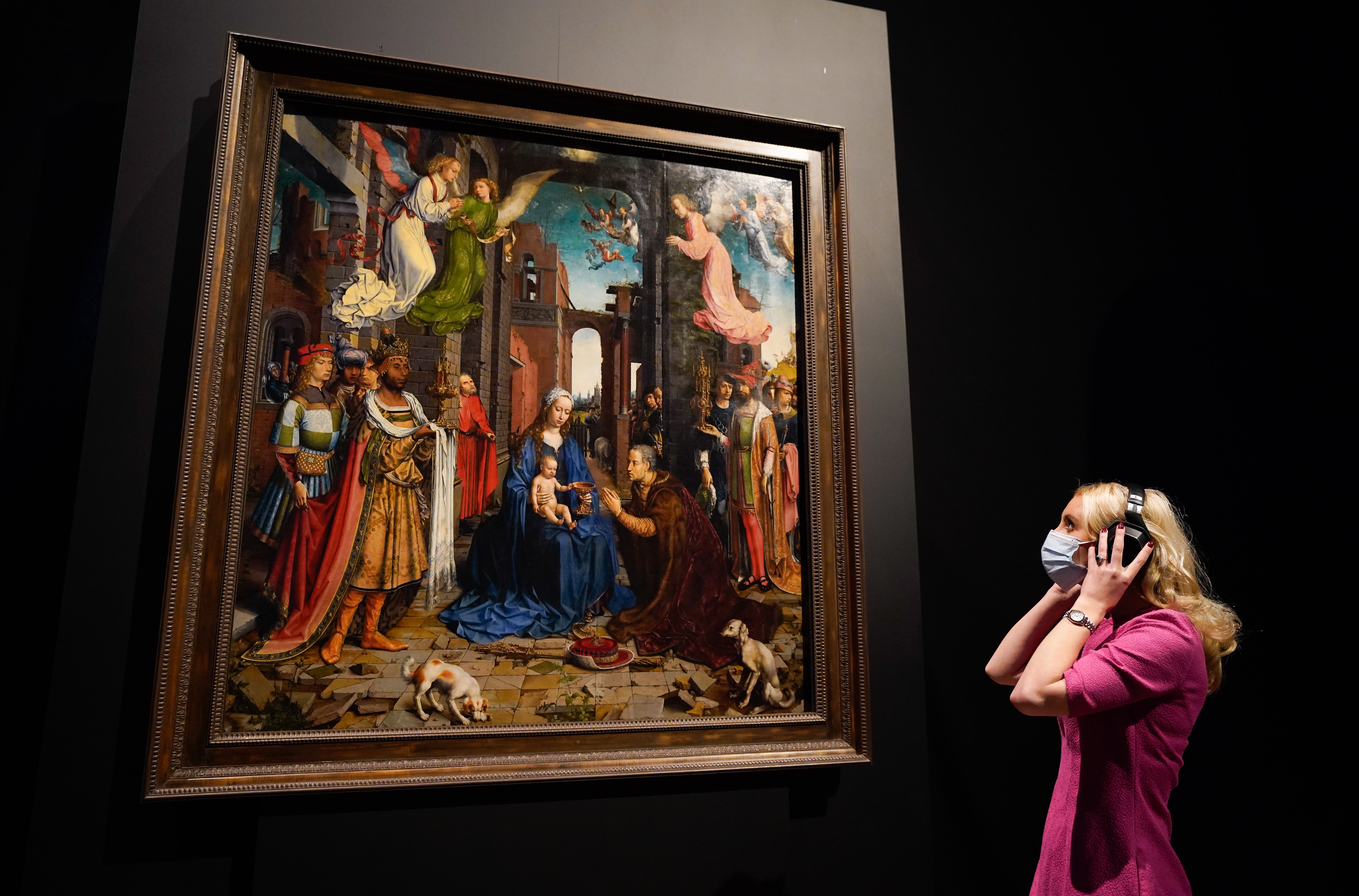 A person looks up at a copy of Jan Gossaert’s Adoration Of The Kings (Andrew Matthews/PA)