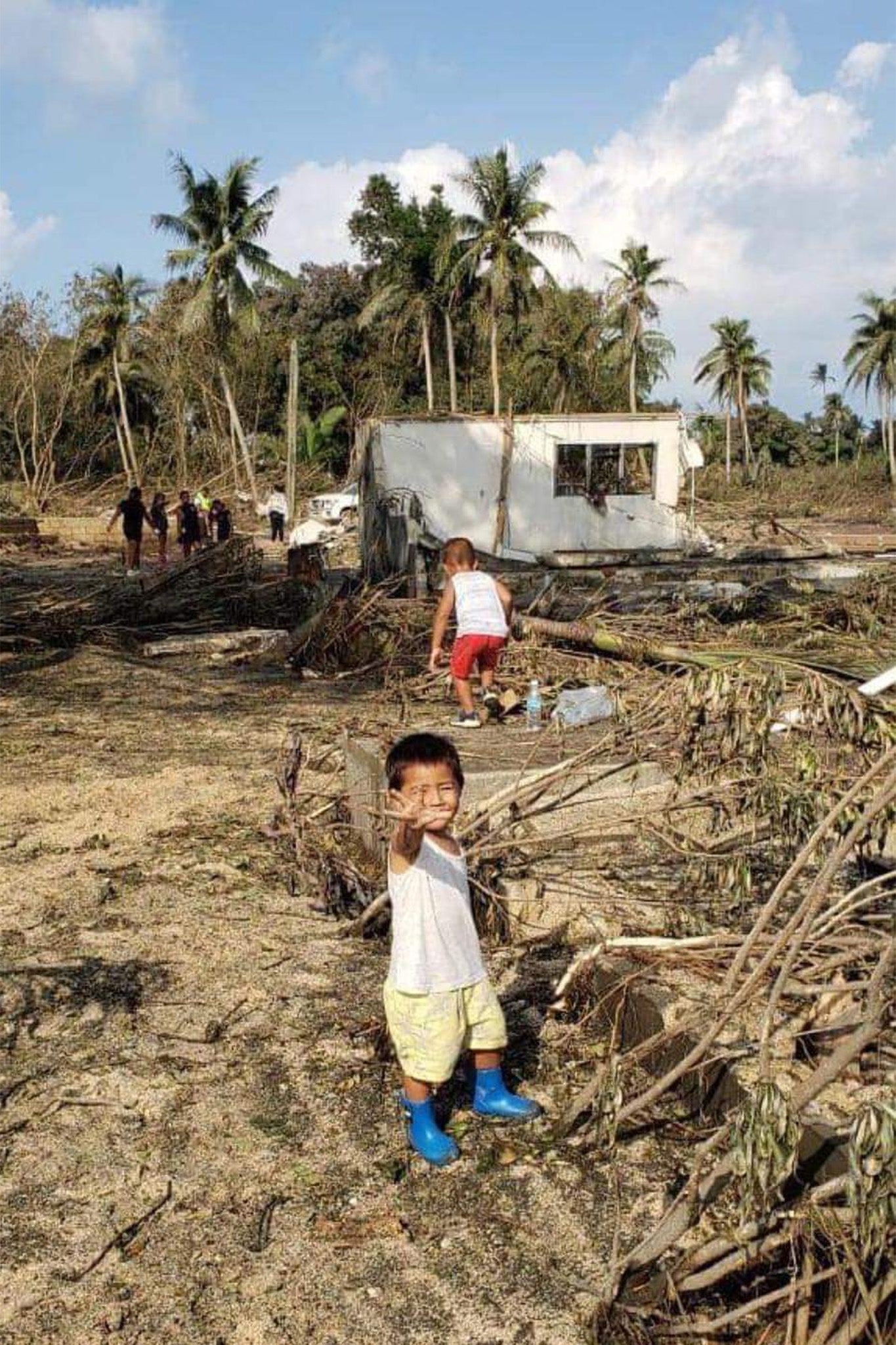 Children in Tonga’s capital amid debris left in the tsunami’s wake