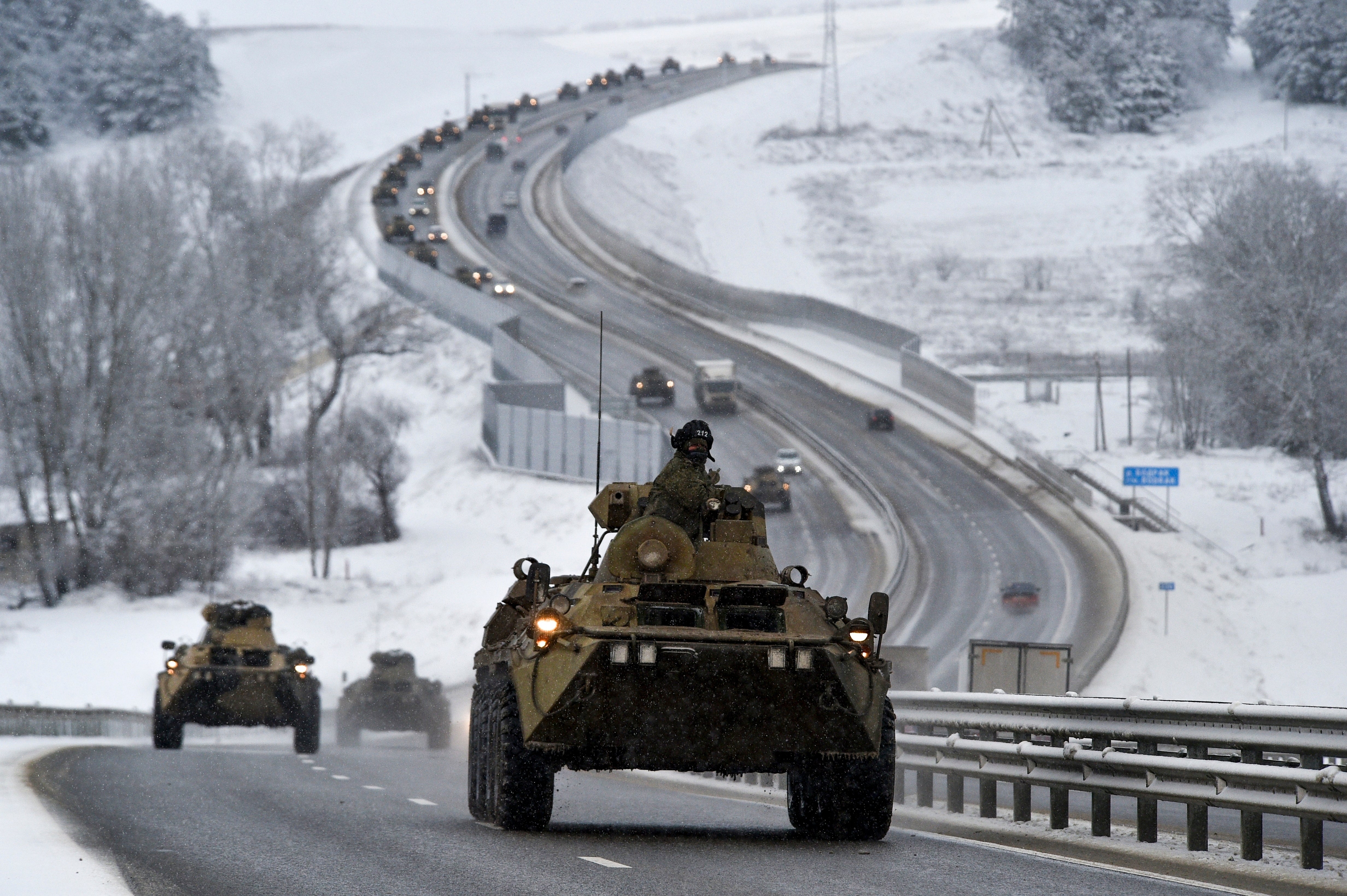 A convoy of Russian armored vehicles moves along a highway in Crimea, 18 January 2022