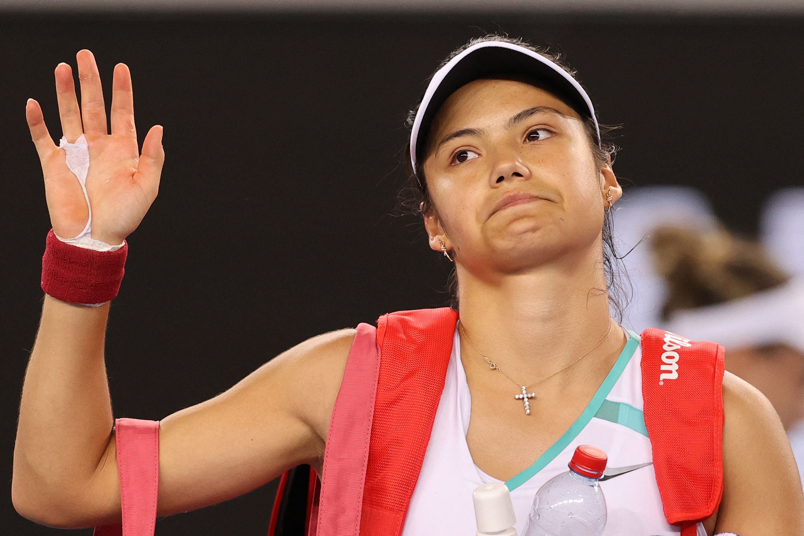 Emma Raducanu waves after losing to Danka Kovinic