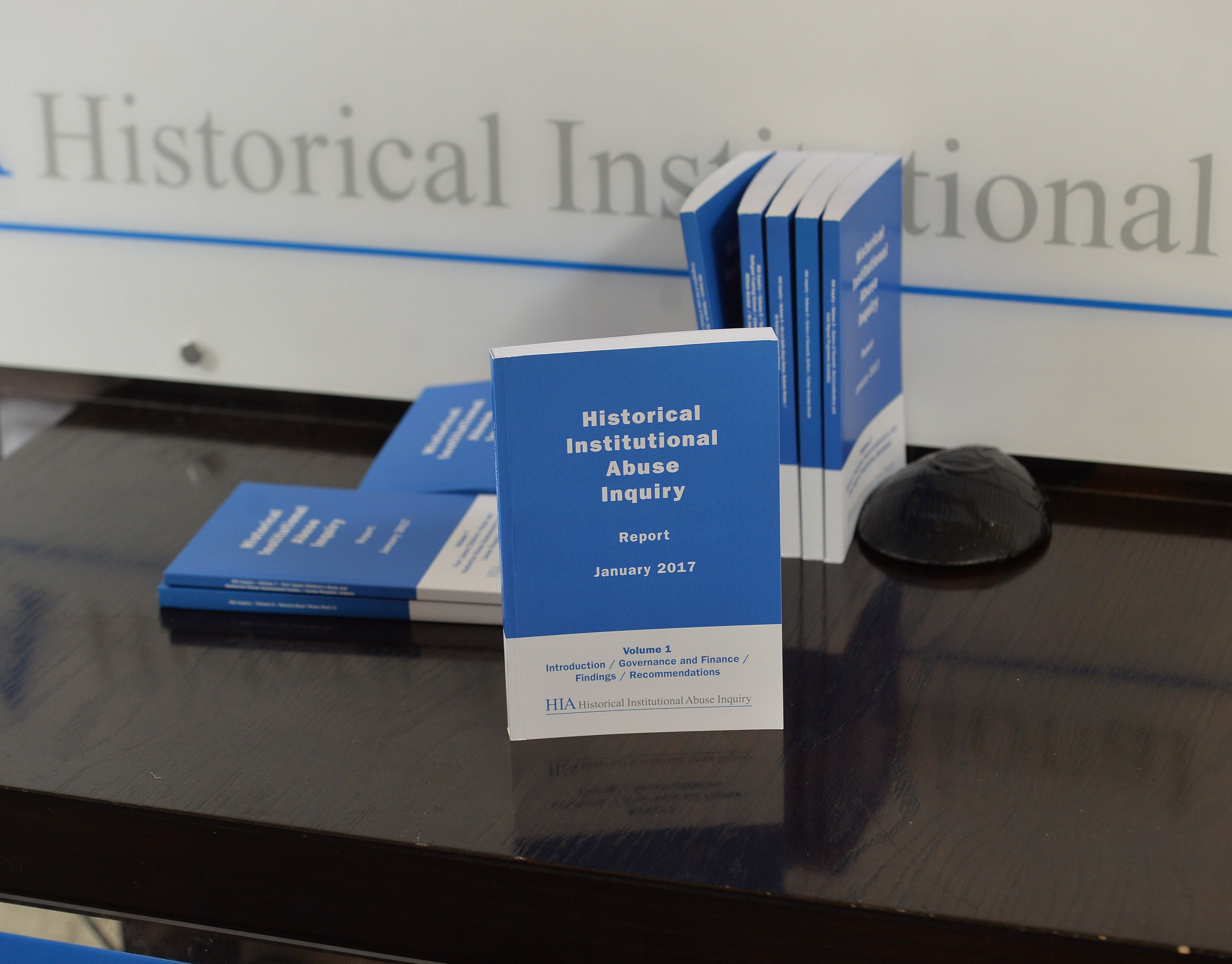 Copies of the Historical Institutional Abuse inquiry report on show during the press conference in Belfast on its publication.