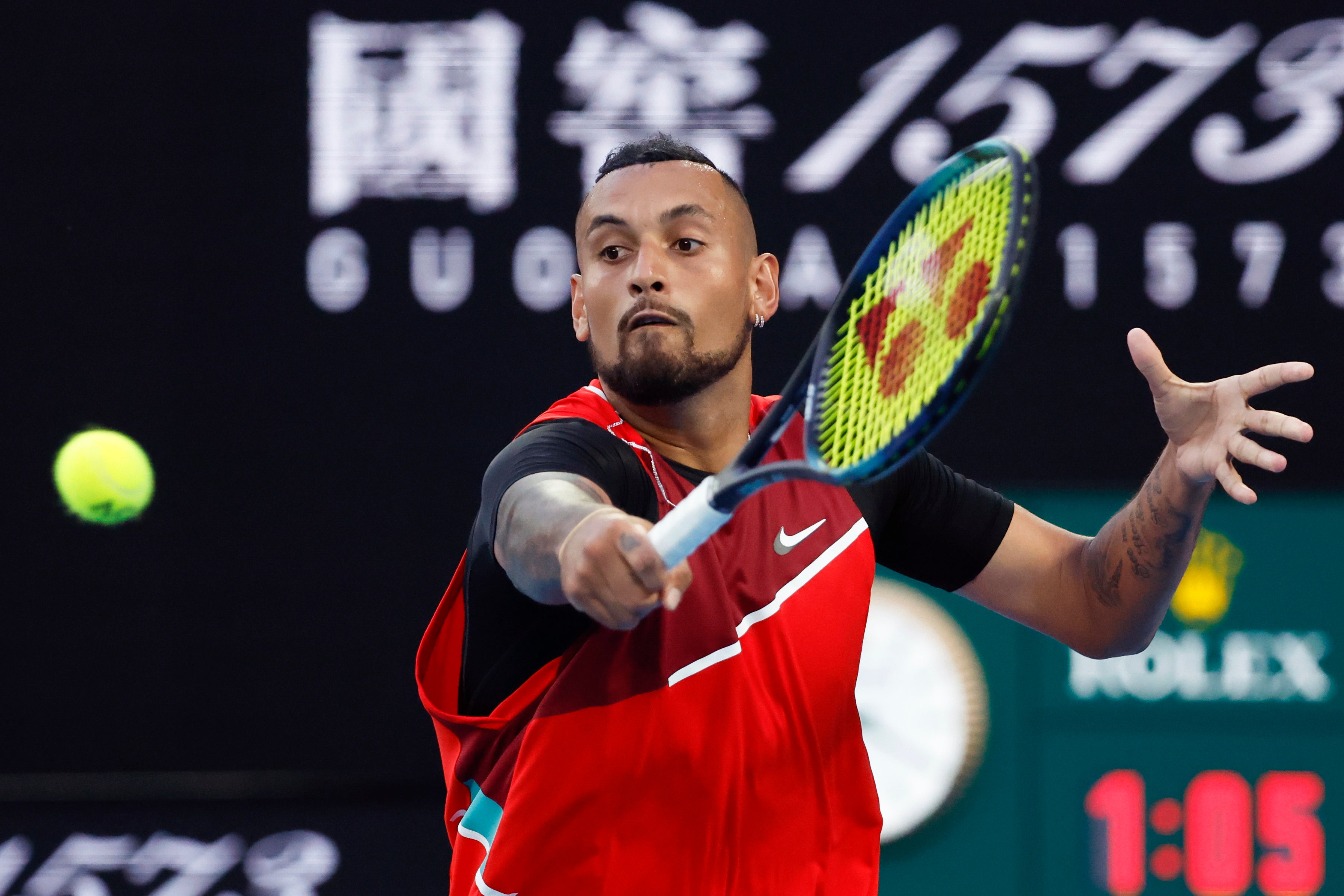 Nick Kyrgios reaches for a volley at the net