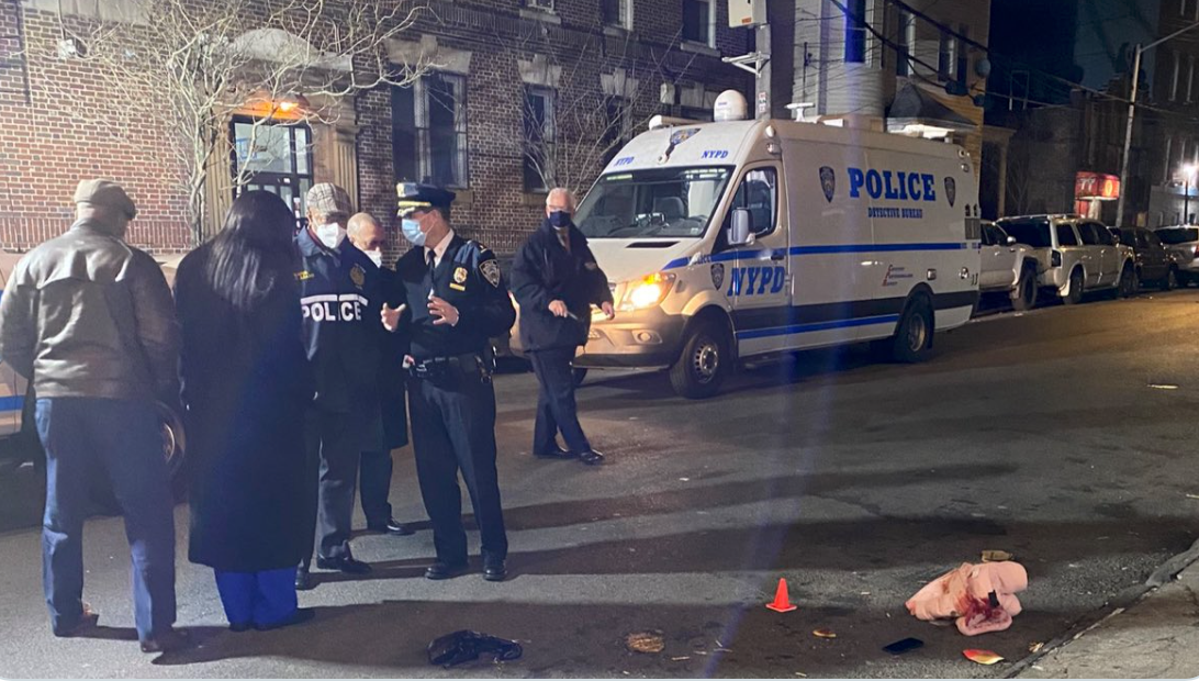 The 11-month-old child’s bloodstained coat lies on the ground surrounded by police markers, as Mayor Eric Adams speaks to police officers