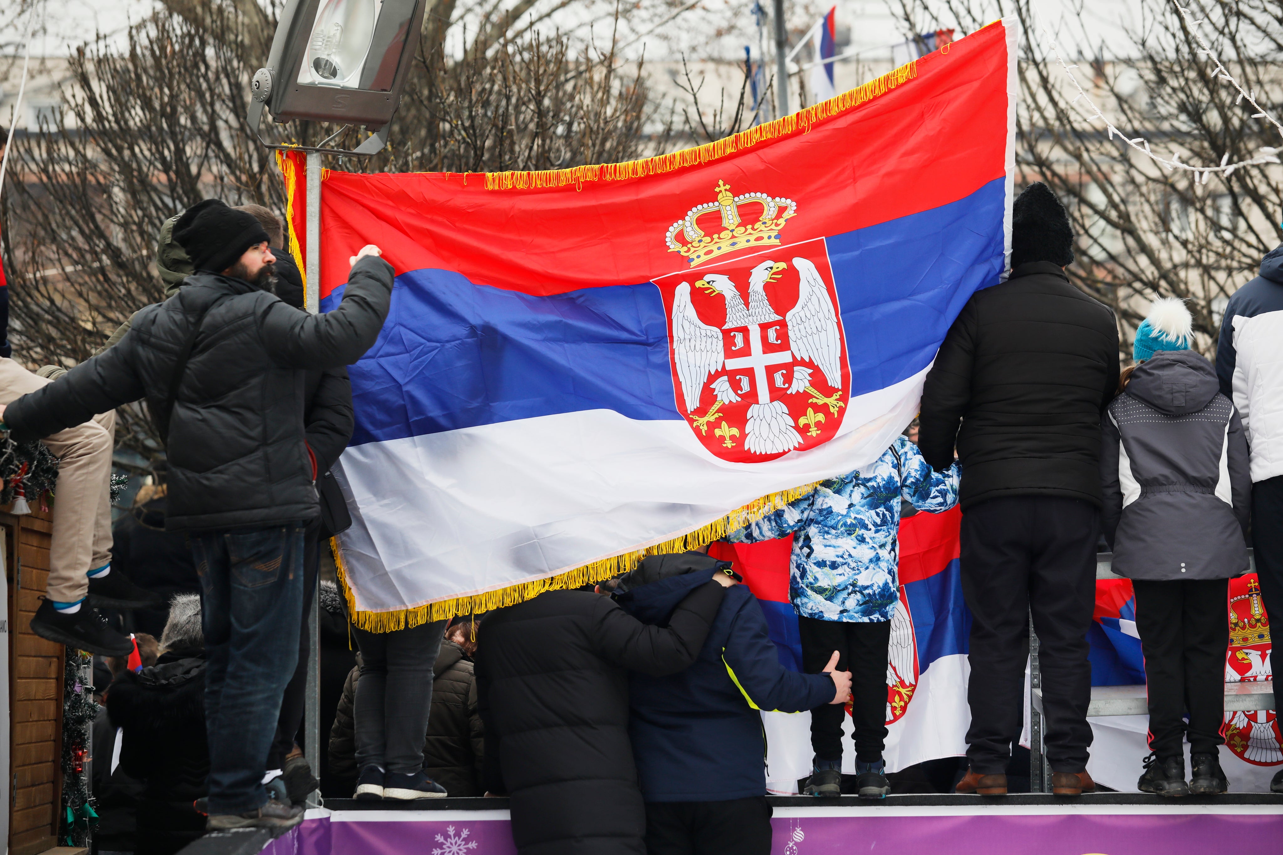 Attendees hold up a Serbian flag during the celebrations on 9 January