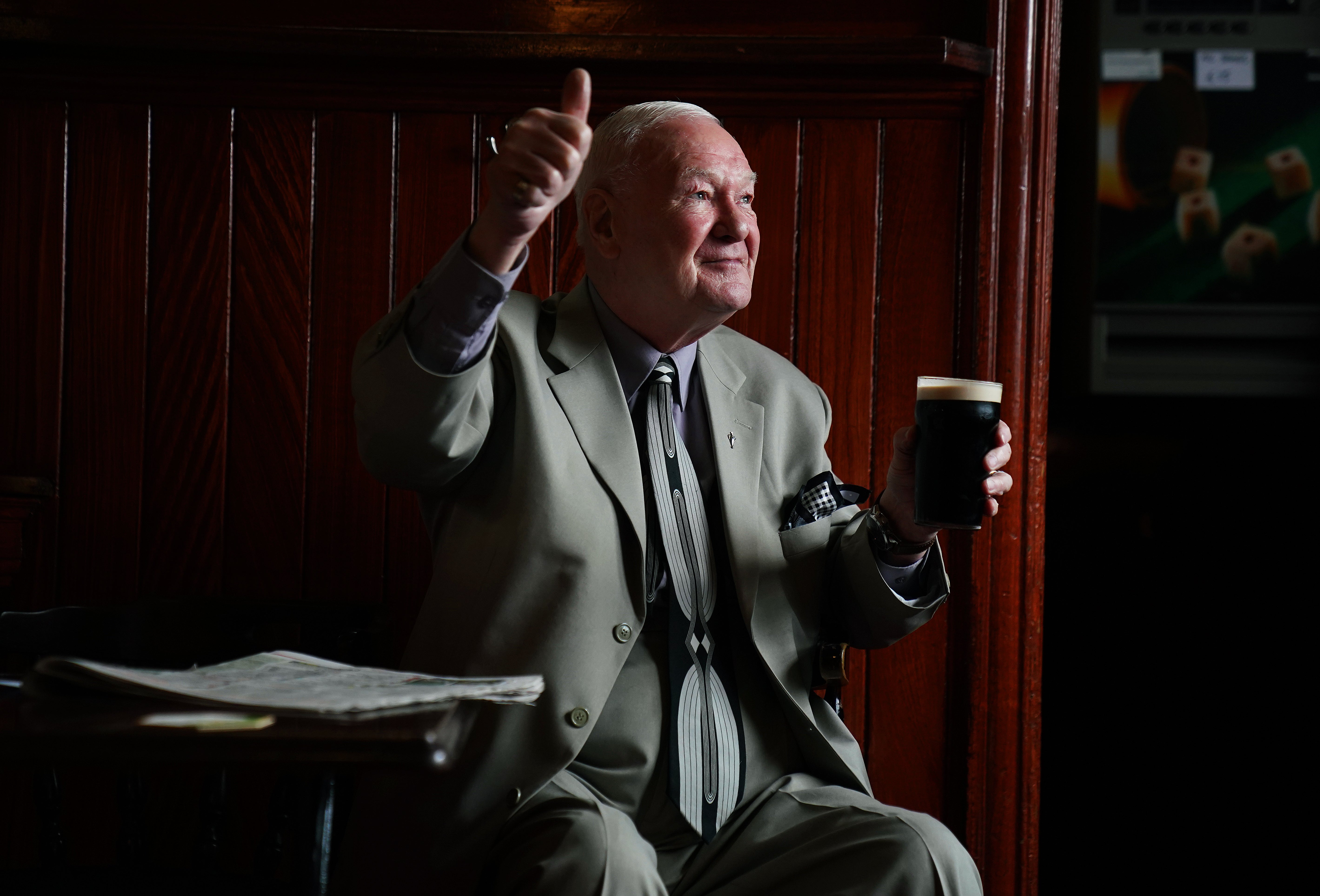 Peter Roche, a regular for 55 years at Mulligans pub in Dublin’s city centre, in conversation while having a pint (Brian Lawless/PA)