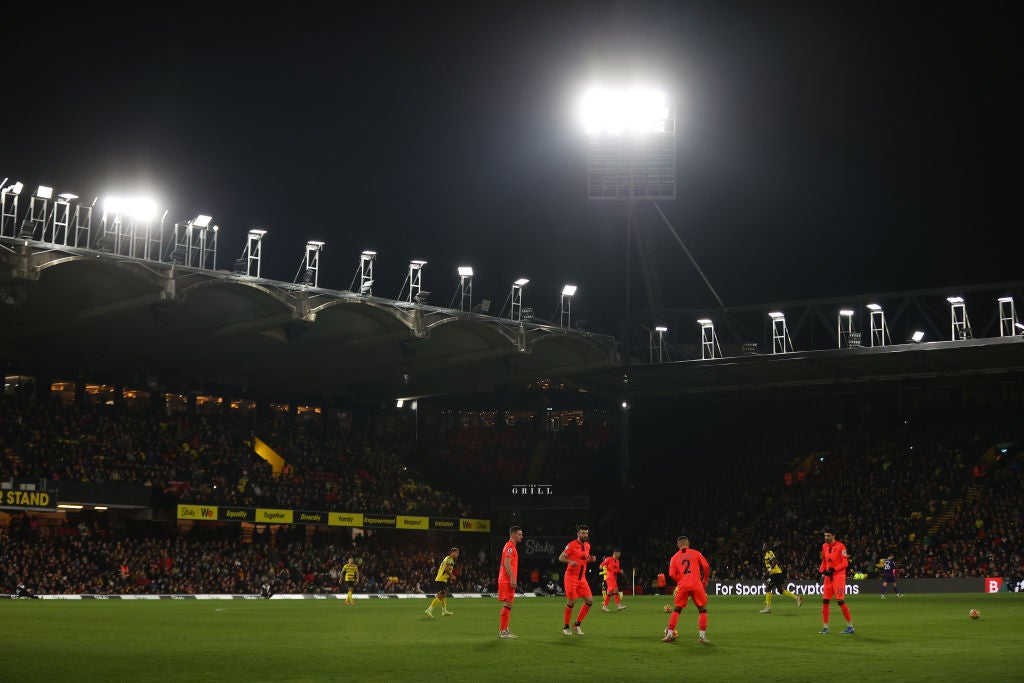 The players do warm-up exercises while waiting for the floodlights to be fixed