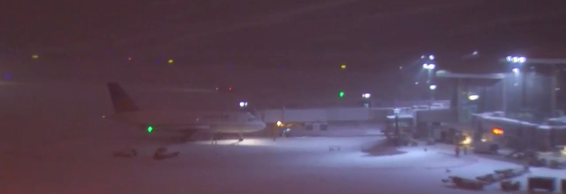 An aeroplane sits on the snow at RDU, shortly after the Delta flight skidded off the runway.