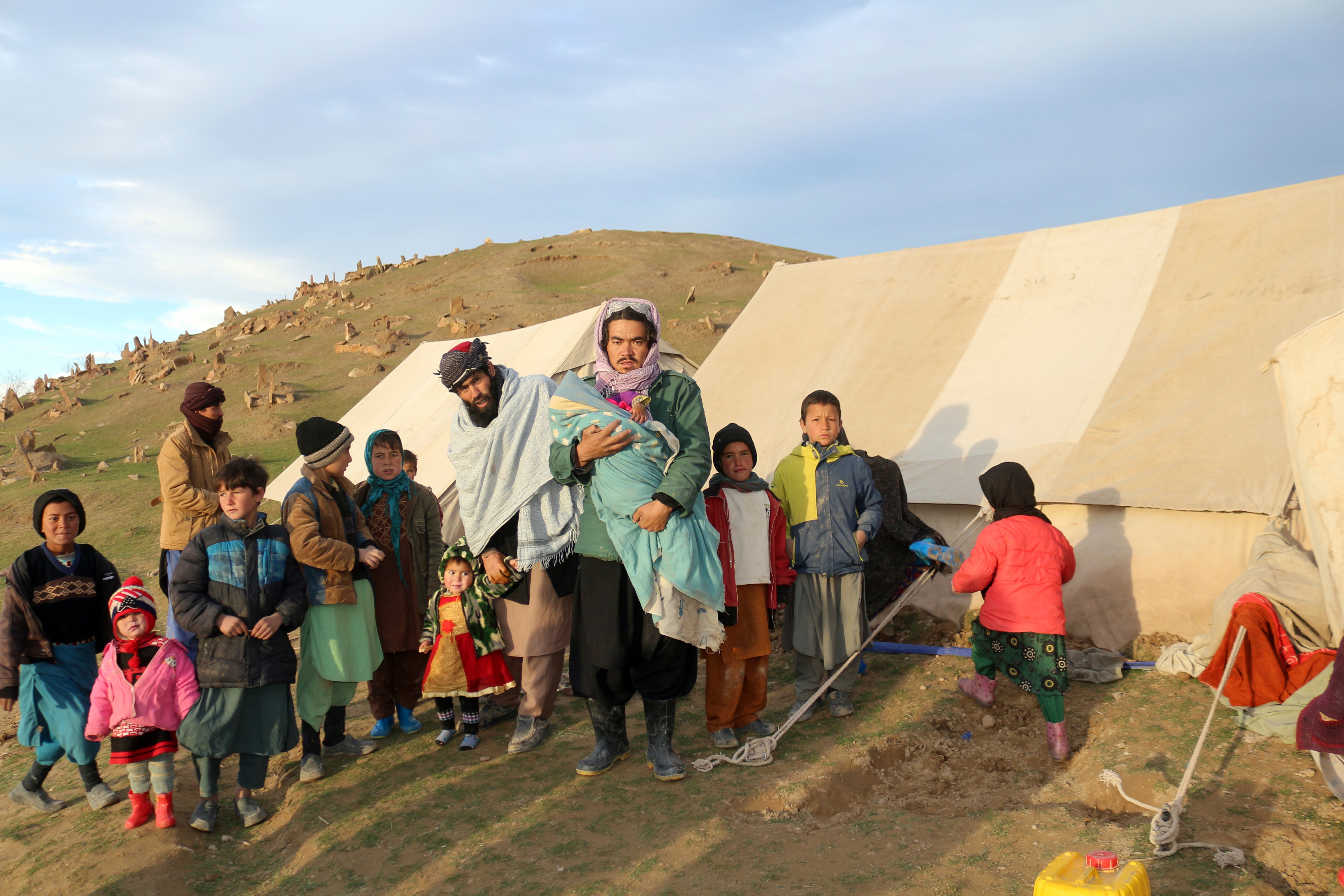 Afghan villagers wait to receive food after their home was damaged by last week’s earthquake in the remote western province of Badghis, (Abdul Raziq Saddiqi/AP)