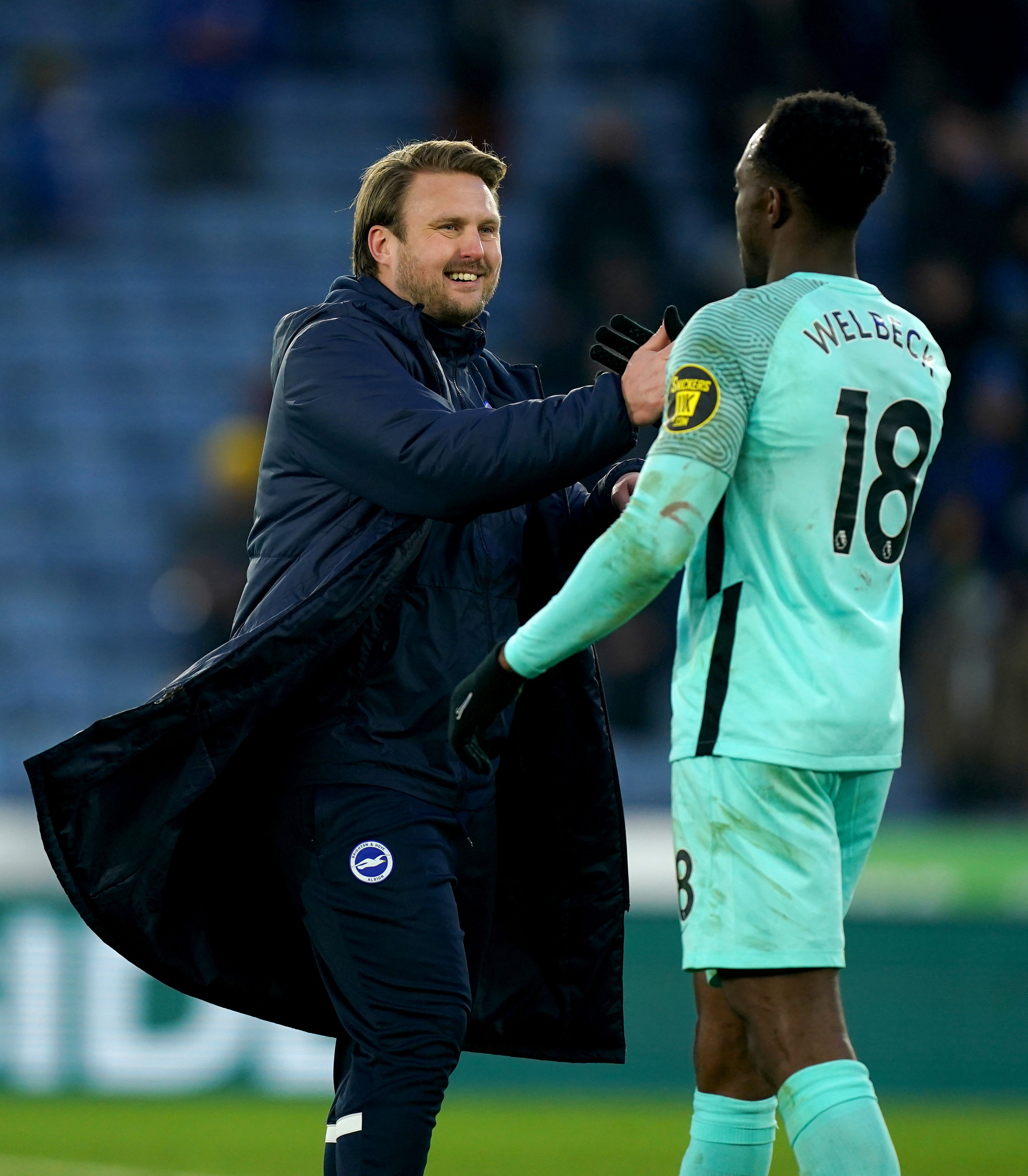 Brighton coach Bjorn Hamberg congratulates goalscorer Danny Welbeck (Mike Egerton/PA)