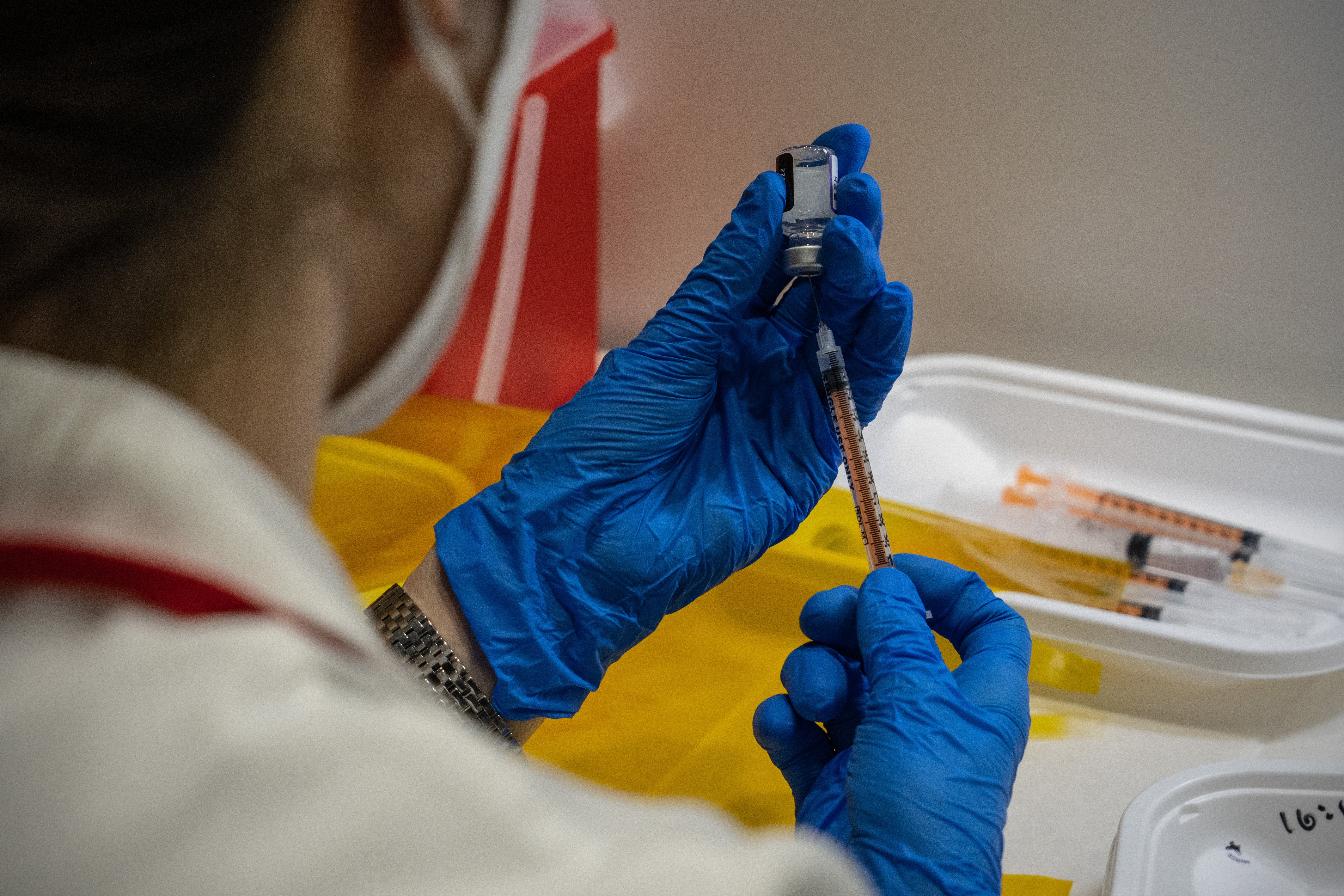 A nurse prepares syringes with the Pfizer coronavirus booster vaccination on 20 January 2022 in Tokyo, Japan