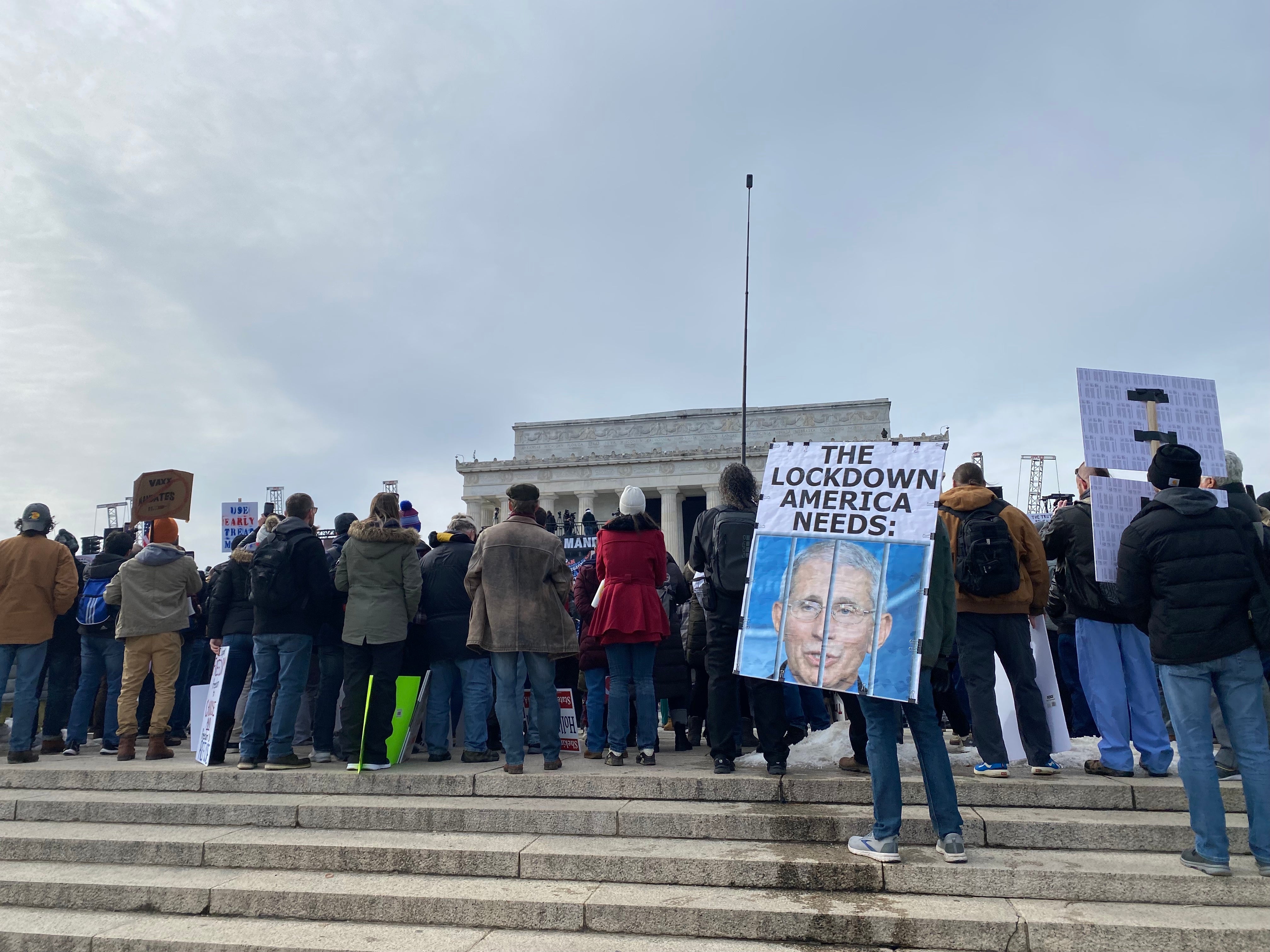 A protester holds a sign calling for the imprisonment of Dr Anthony Fauci at a rally against vaccine mandates in Washington DC.