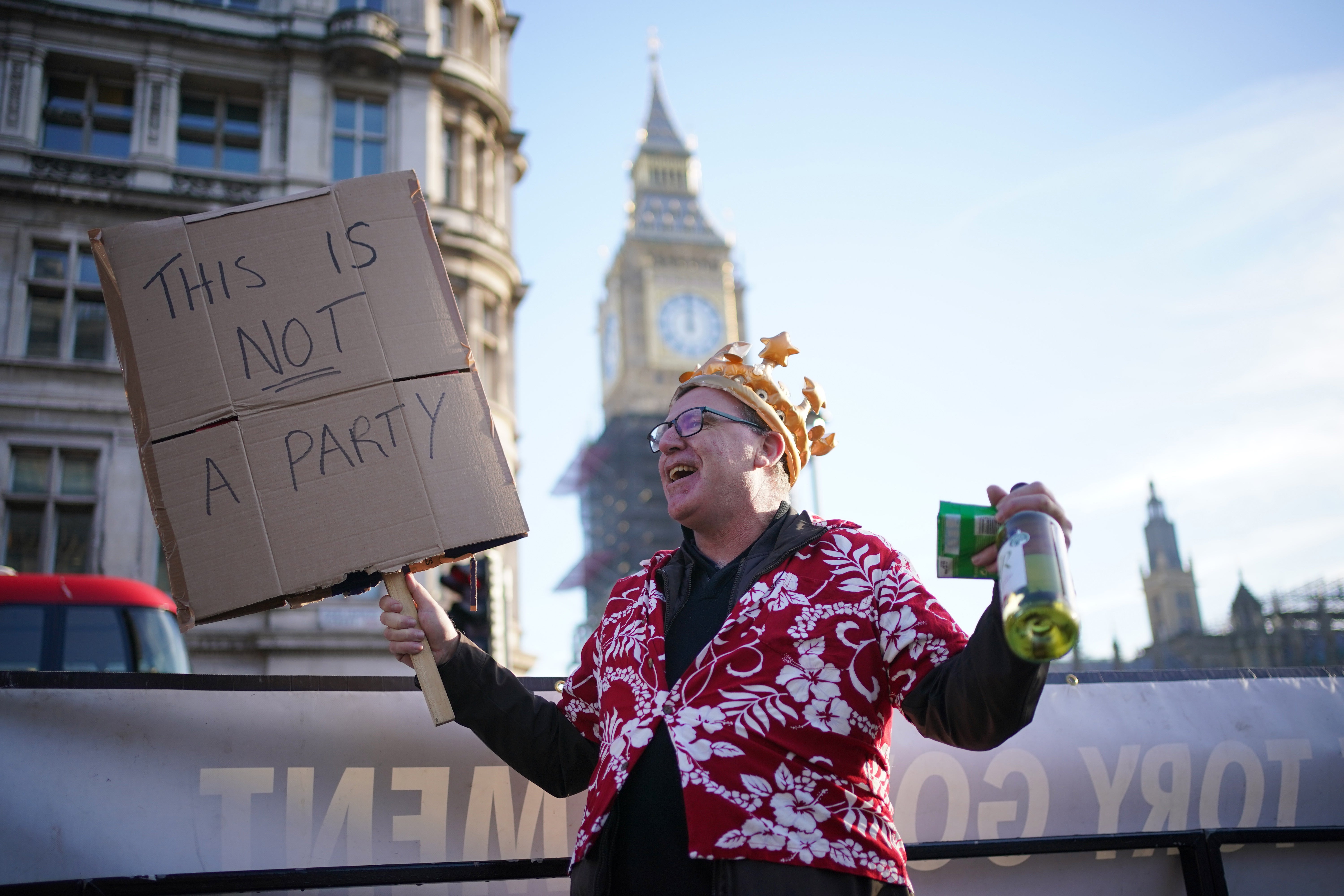 A protestor in Parliament Square amid public anger over lockdown parties (Dominic Lipinski/PA)