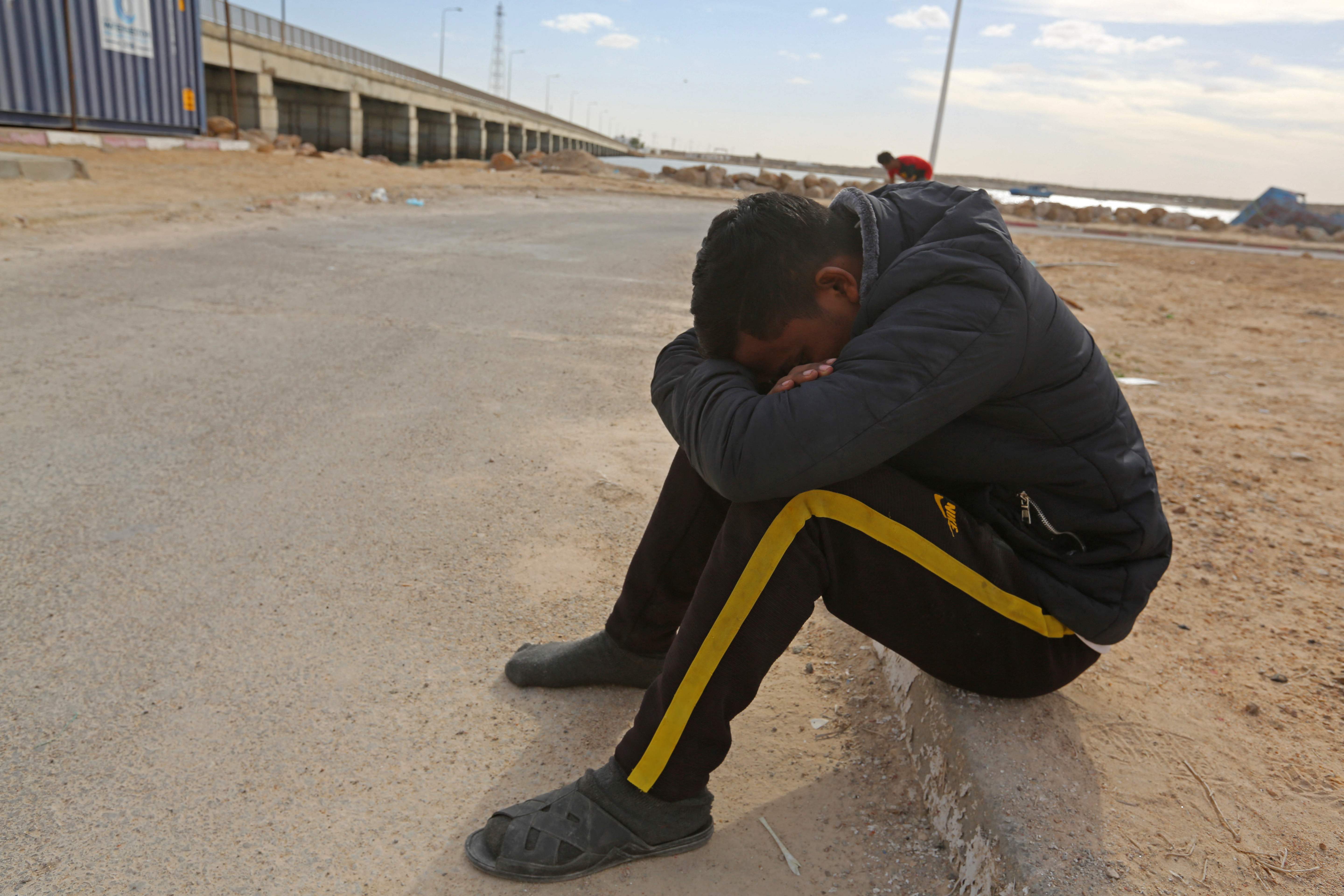 A migrant rescued by Tunisia’s national guard rests in Ben Guerdane, southern Tunisia, 6 January 2022