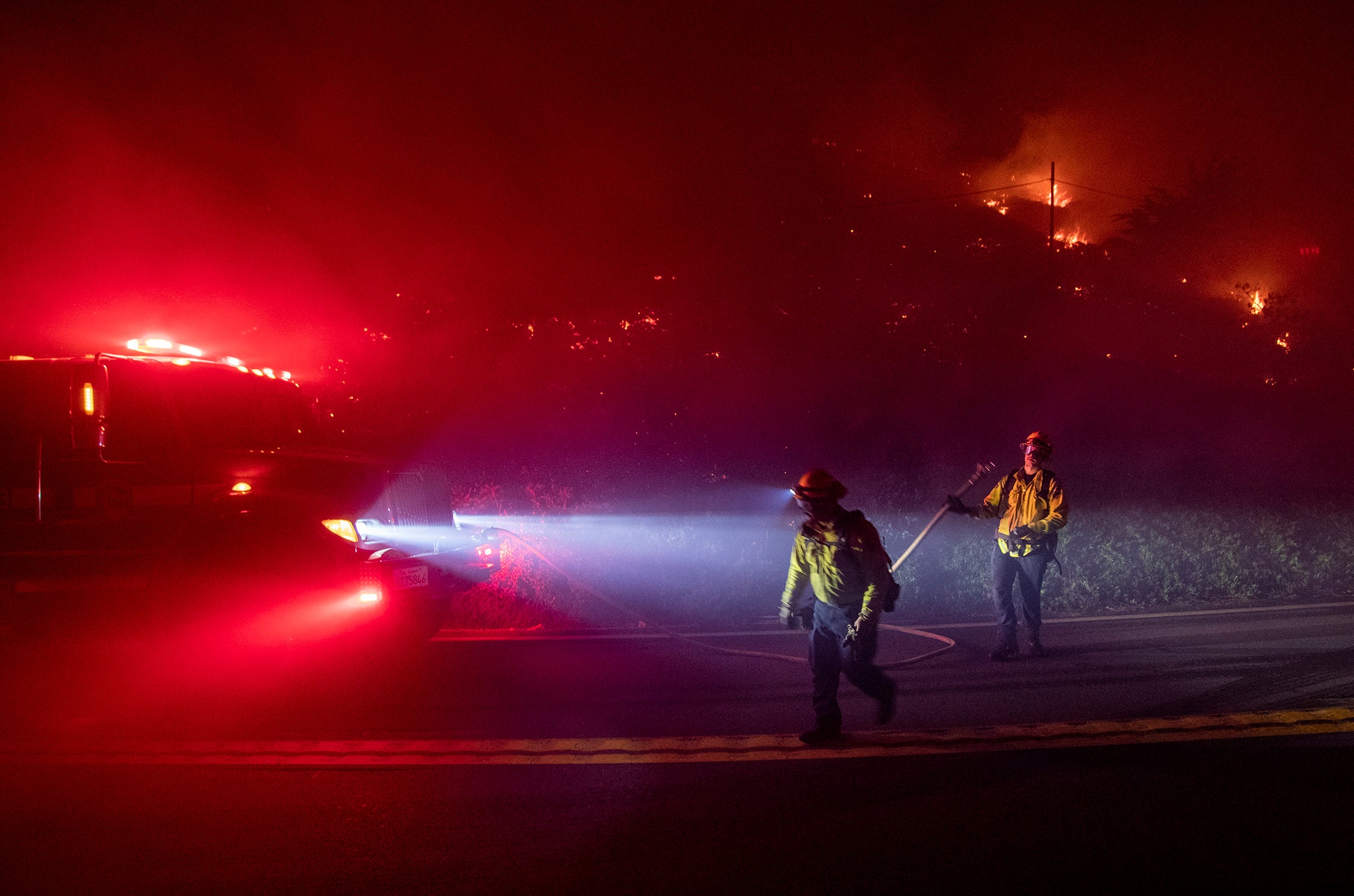 Firefighters battle the Colorado Fire burning along Highway 1 in Big Sur, California.