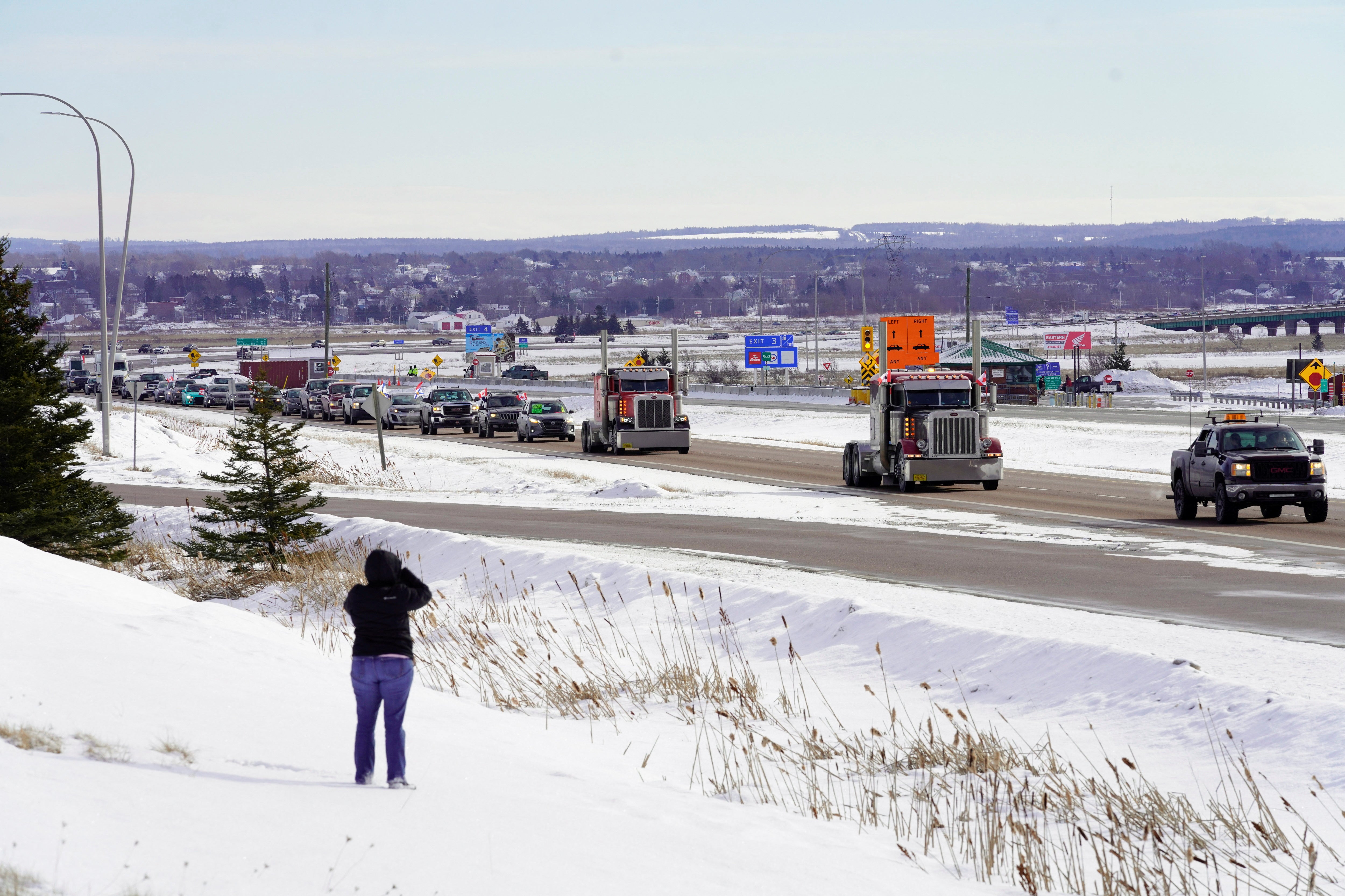 Truck drivers protesting against coronavirus disease (COVID-19) vaccine mandates drive in a convoy on the Nova Scotia/New Brunswick provincial boundary in Fort Lawrence, Nova Scotia, Canada, January 23