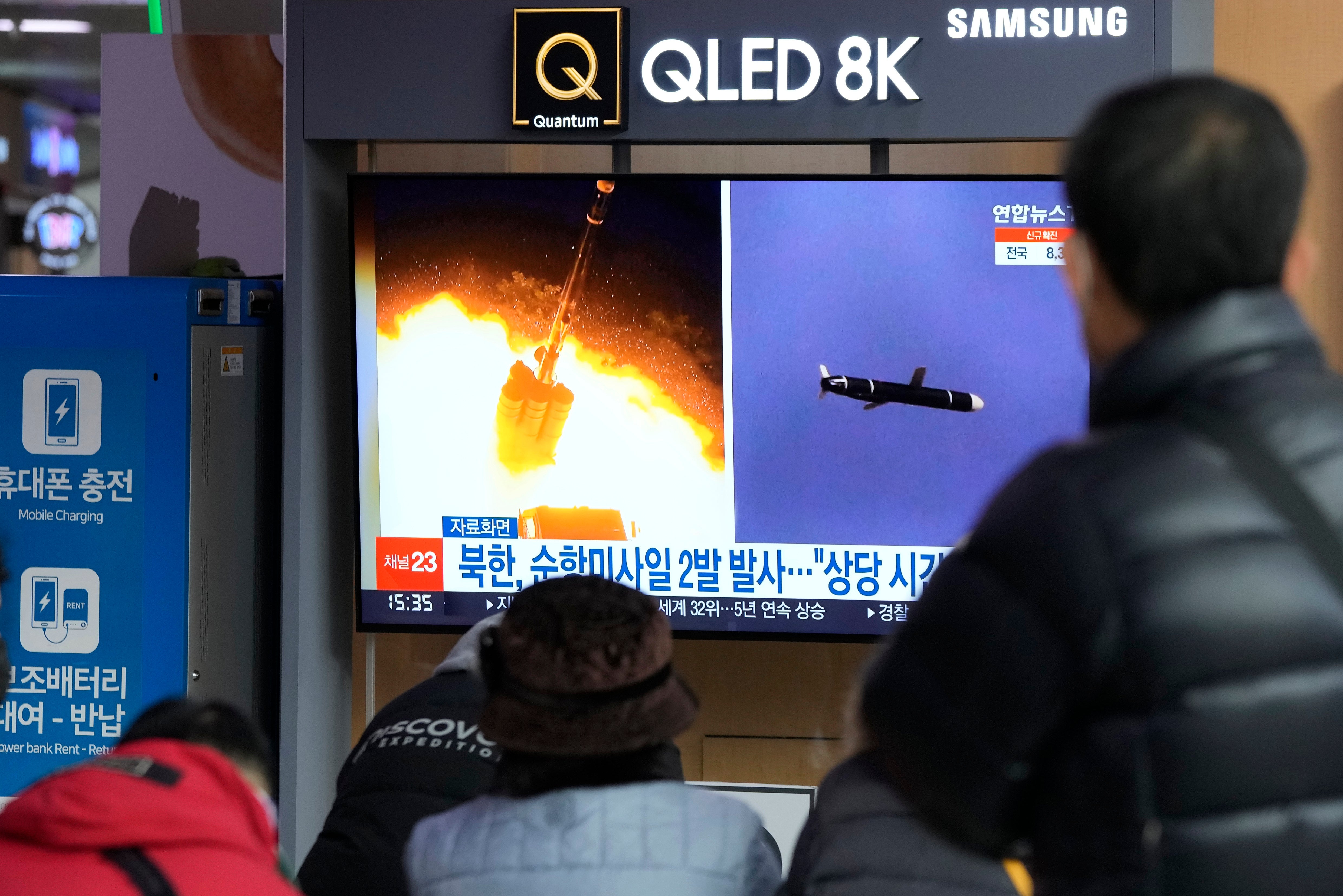 File: People watch a TV showing file images of North Korea’s missile launch