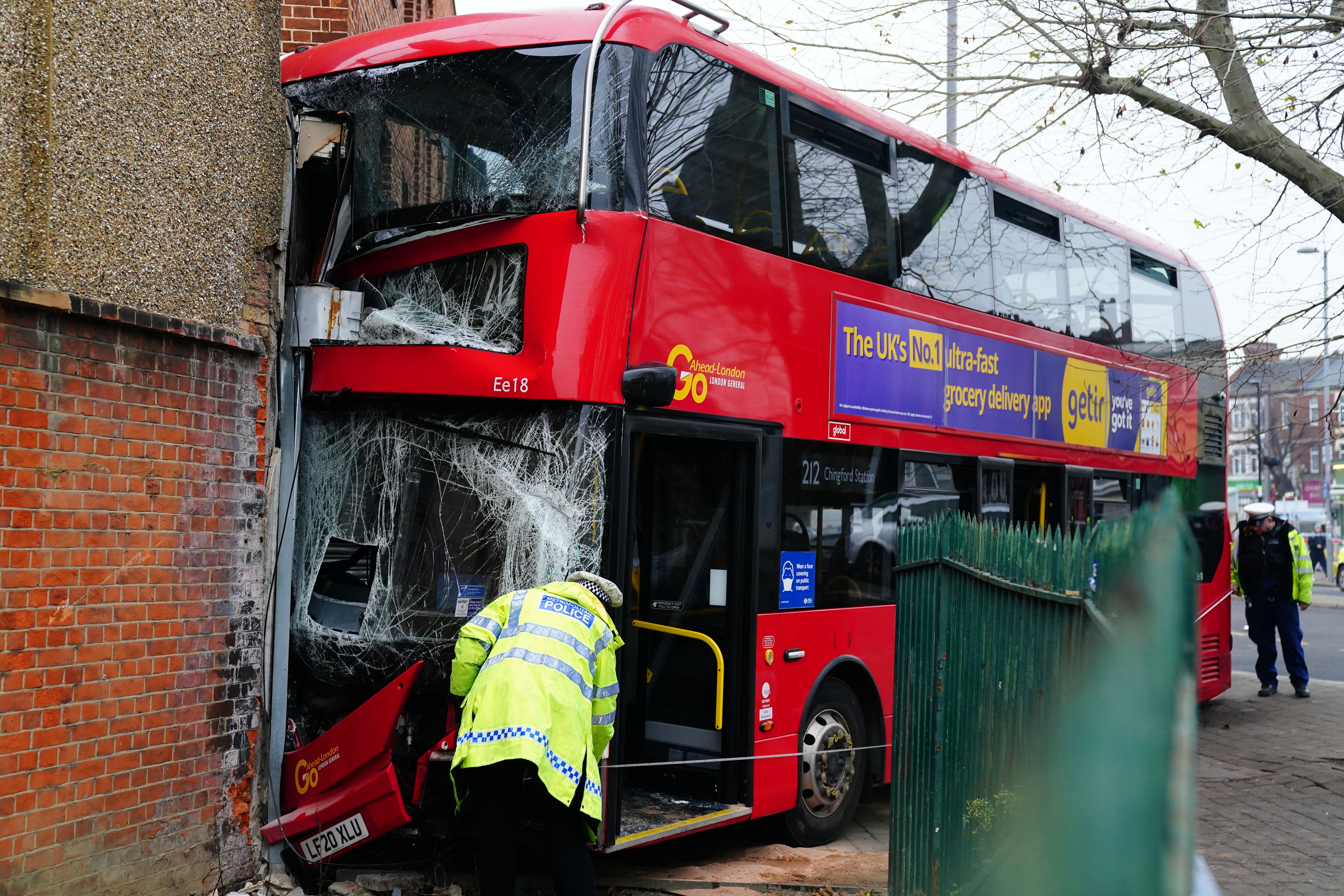 Emergency services at the scene on The Broadway in Highams Park, east London, where a number of people are being treated by paramedics from the London Ambulance Service after a bus collided with a building. Picture date: Tuesday January 25, 2022.