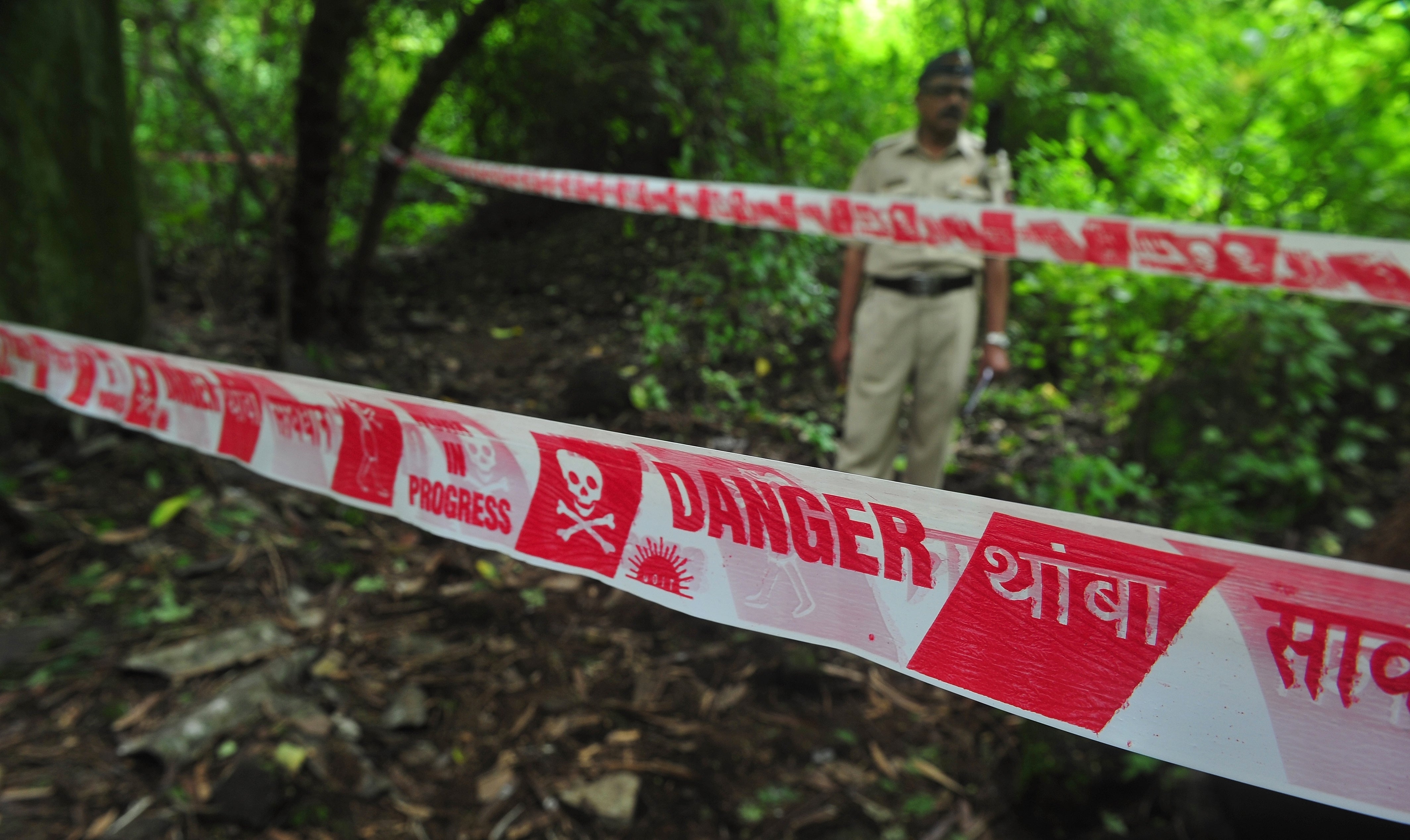 Representational: A policeman keeps watch near a police cordon at a crime scene