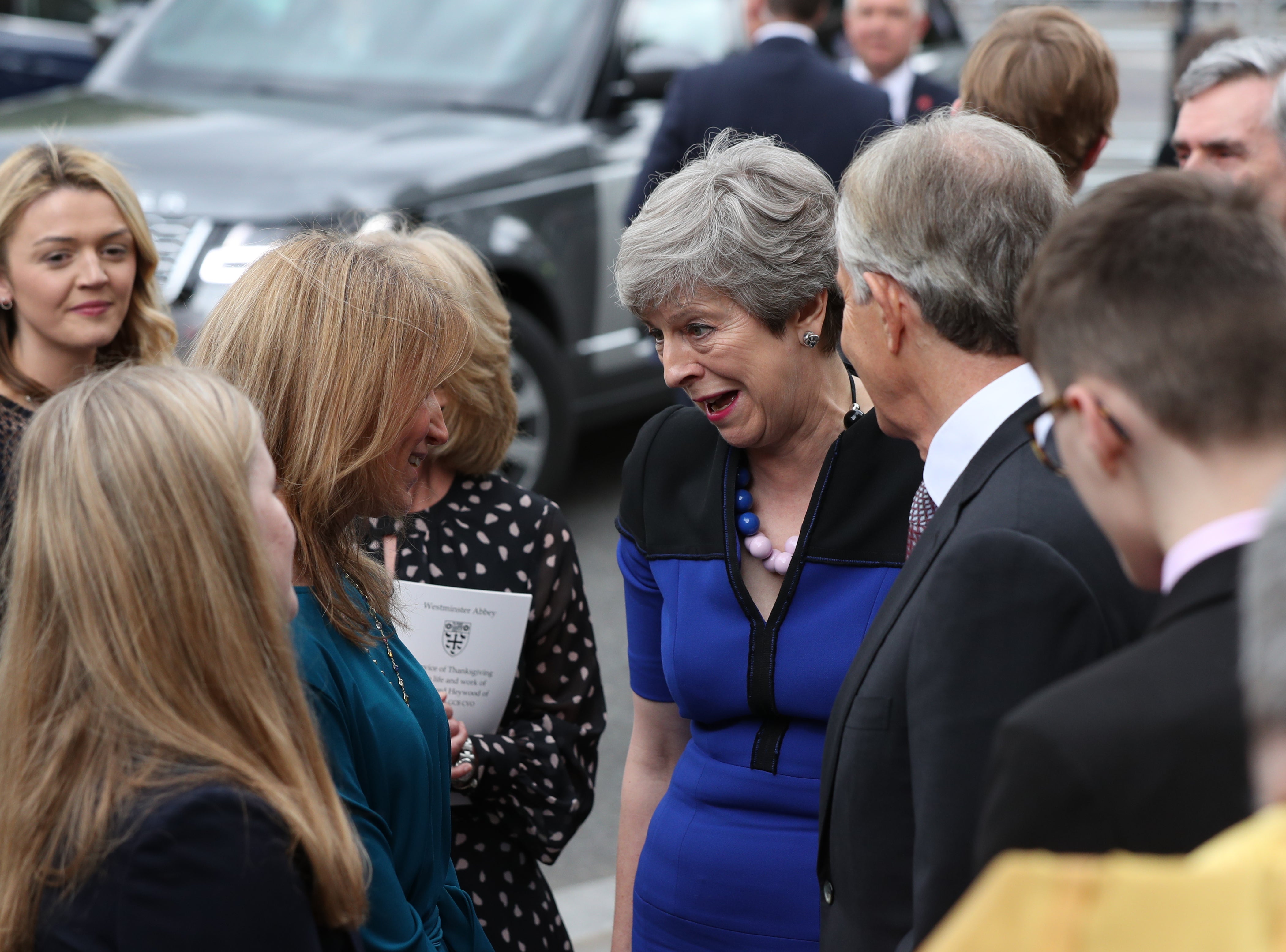 May speaks with Suzanne Heywood, the widow of Lord Heywood, following a service of thanksgiving