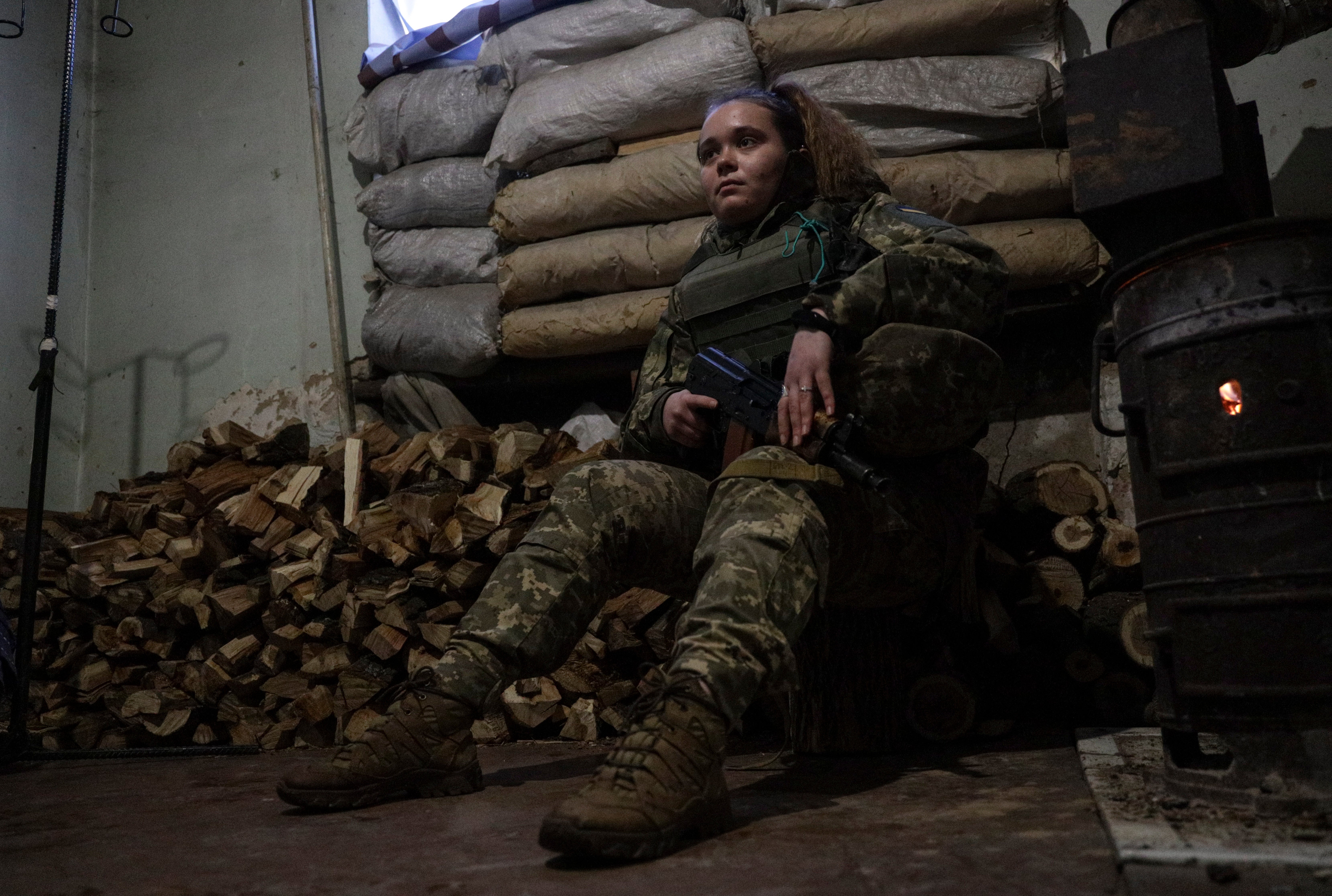 Ukrainian serviceman Anastasia (21) rests in a shelter on a front line near the Russian border