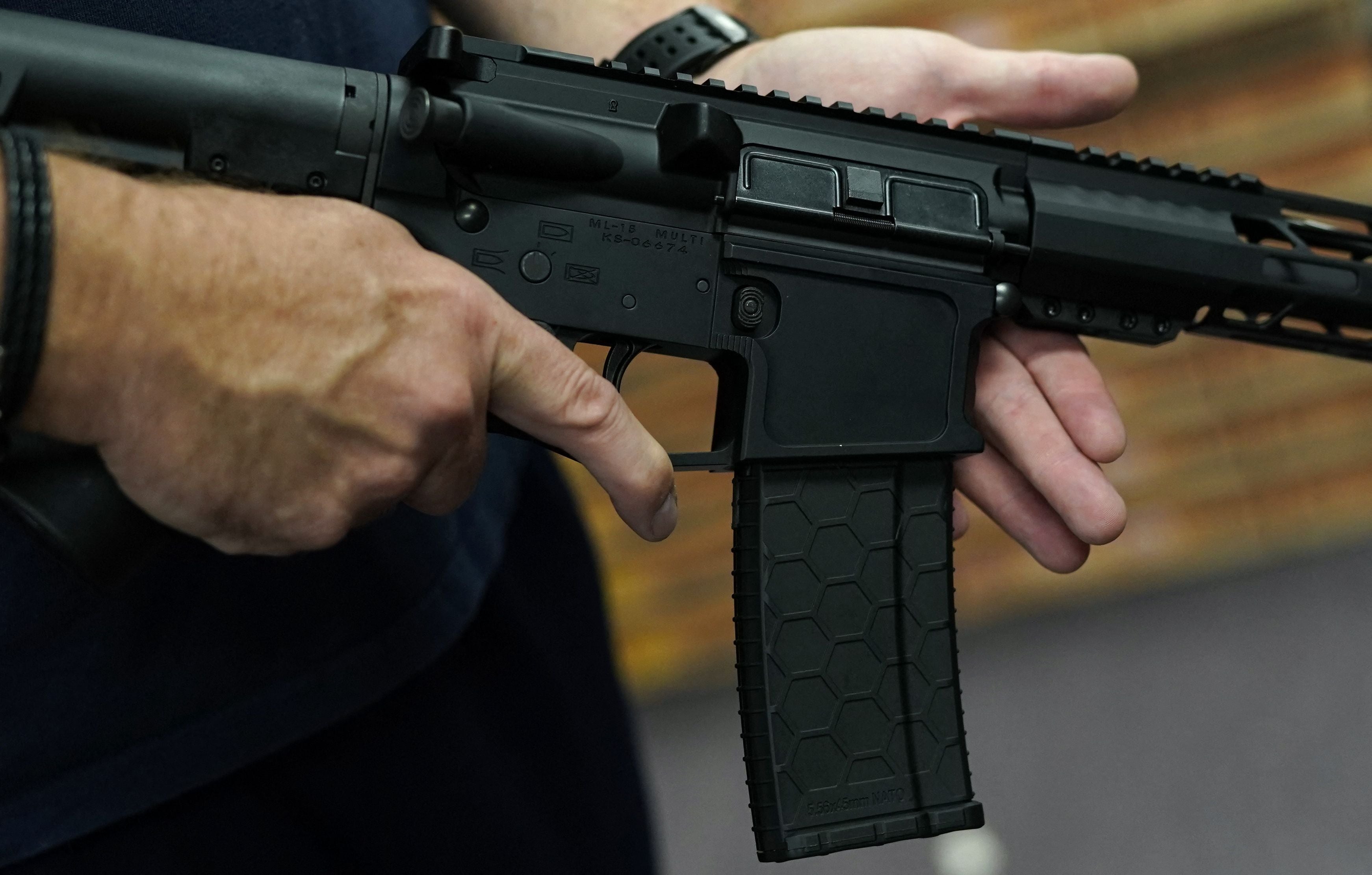 File: A customer handles an AR-15