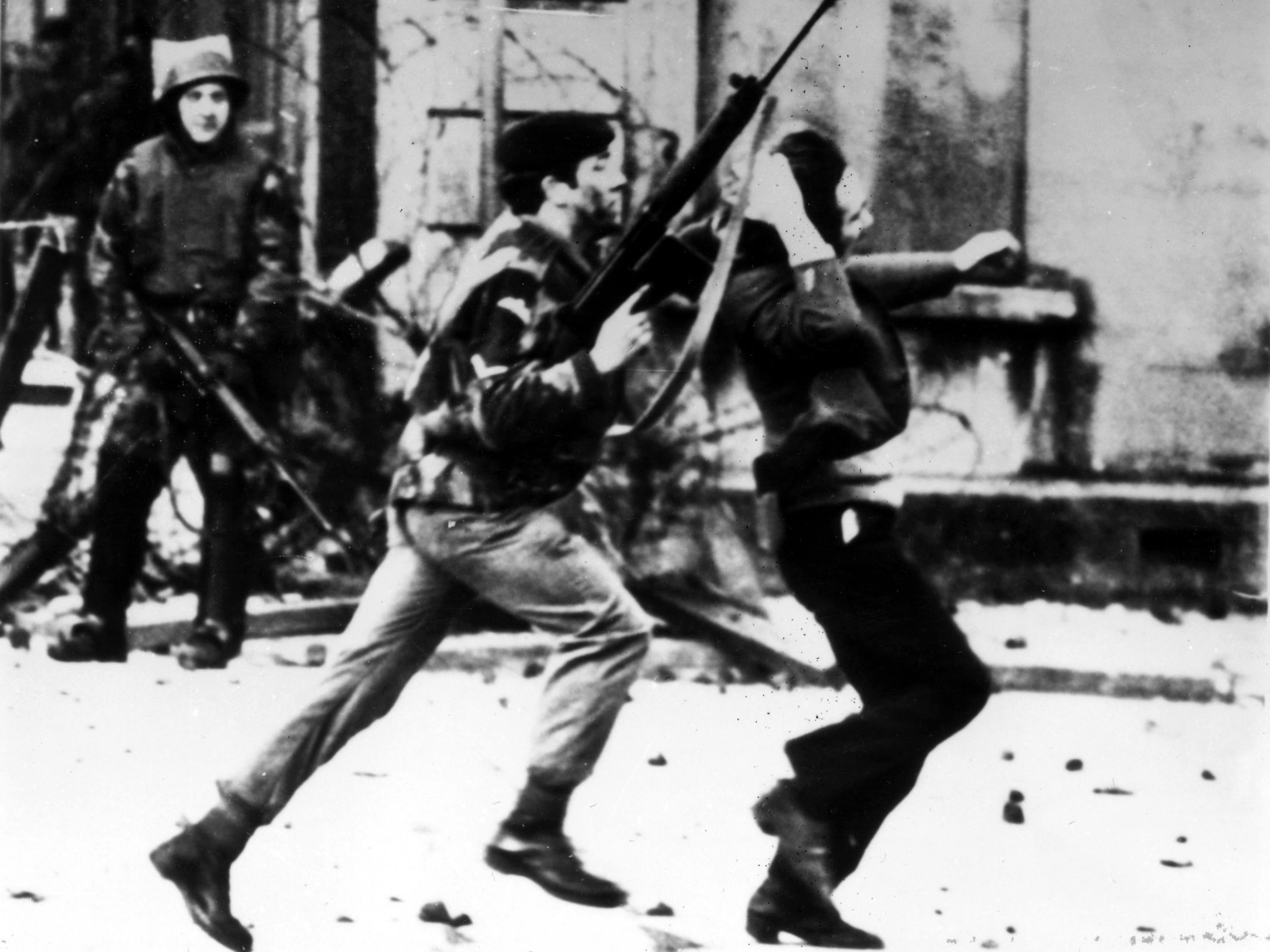 A British paratrooper takes a captured youth from the crowd on Bloody Sunday in Derry, Northern Ireland, on 30 January 1972