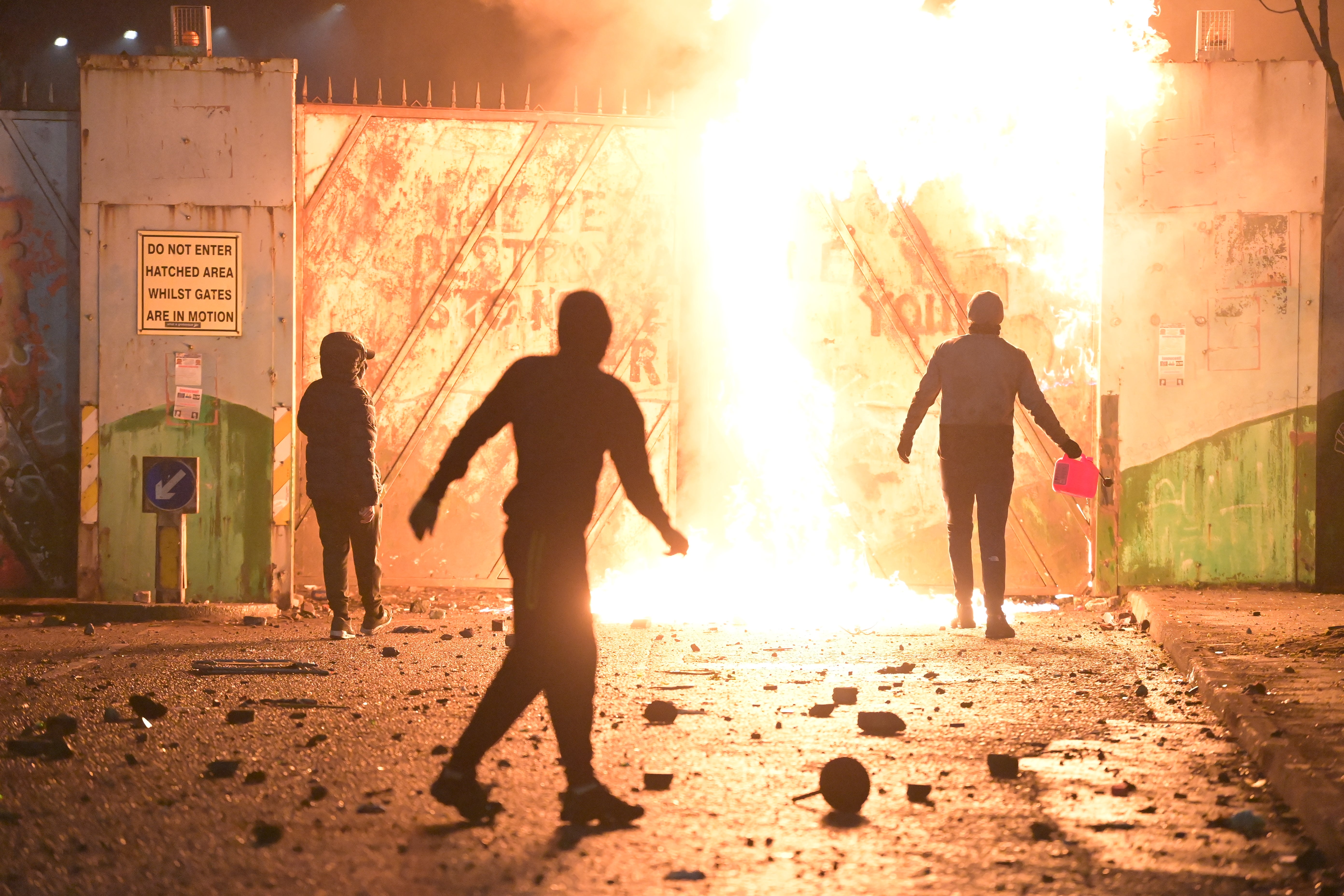 Fire fed by petrol burns as loyalist youths clash with Belfast police at the Peace Gate at the Springfield Road/Lanark Way interface, on 7 April 2021