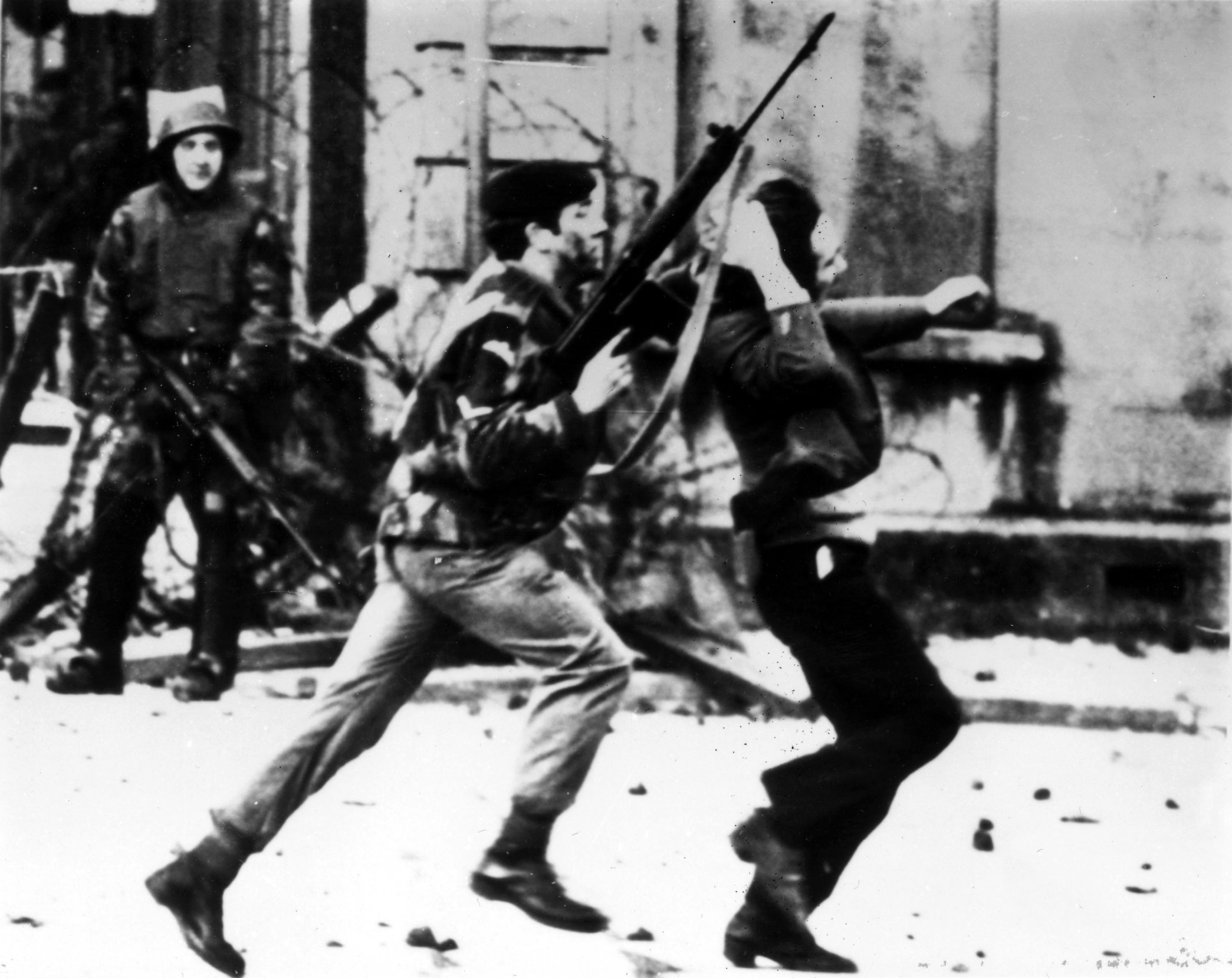 A British paratrooper takes a captured youth from the crowd on Bloody Sunday