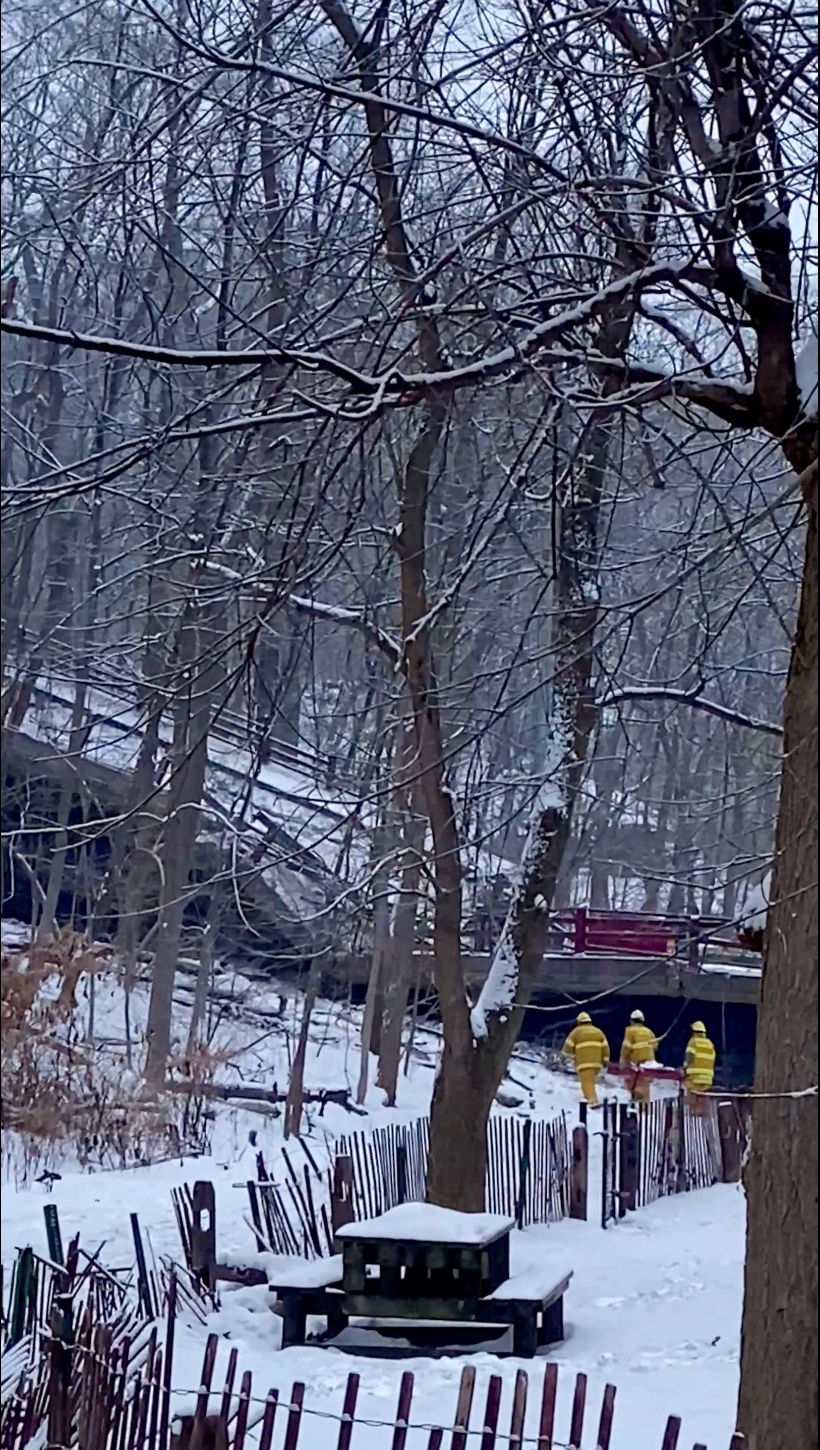 Emergency services work at the scene of a collapsed bridge in Pittsburgh, Pennsylvania, U.S. January 28, 2022, in this image obtained from social media video