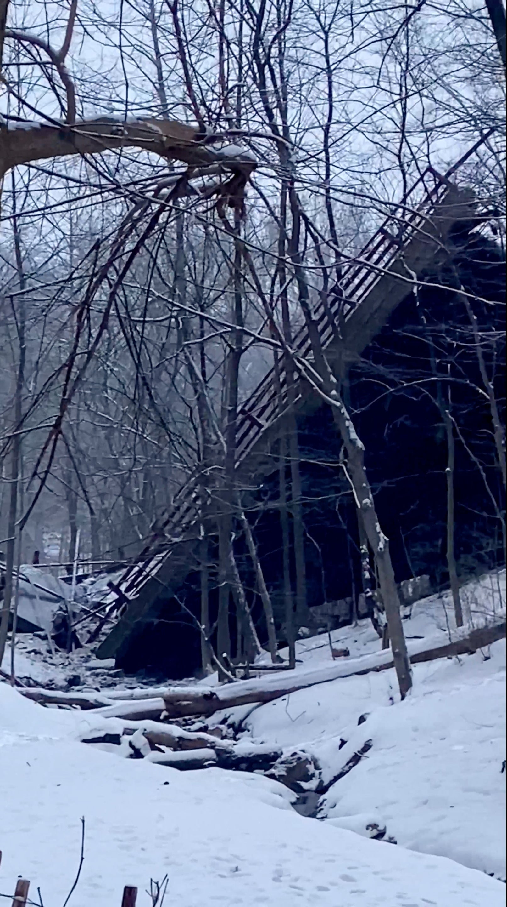 A general view shows a collapsed bridge in Pittsburgh, Pennsylvania, U.S. January 28, 2022, in this image obtained from a social media video