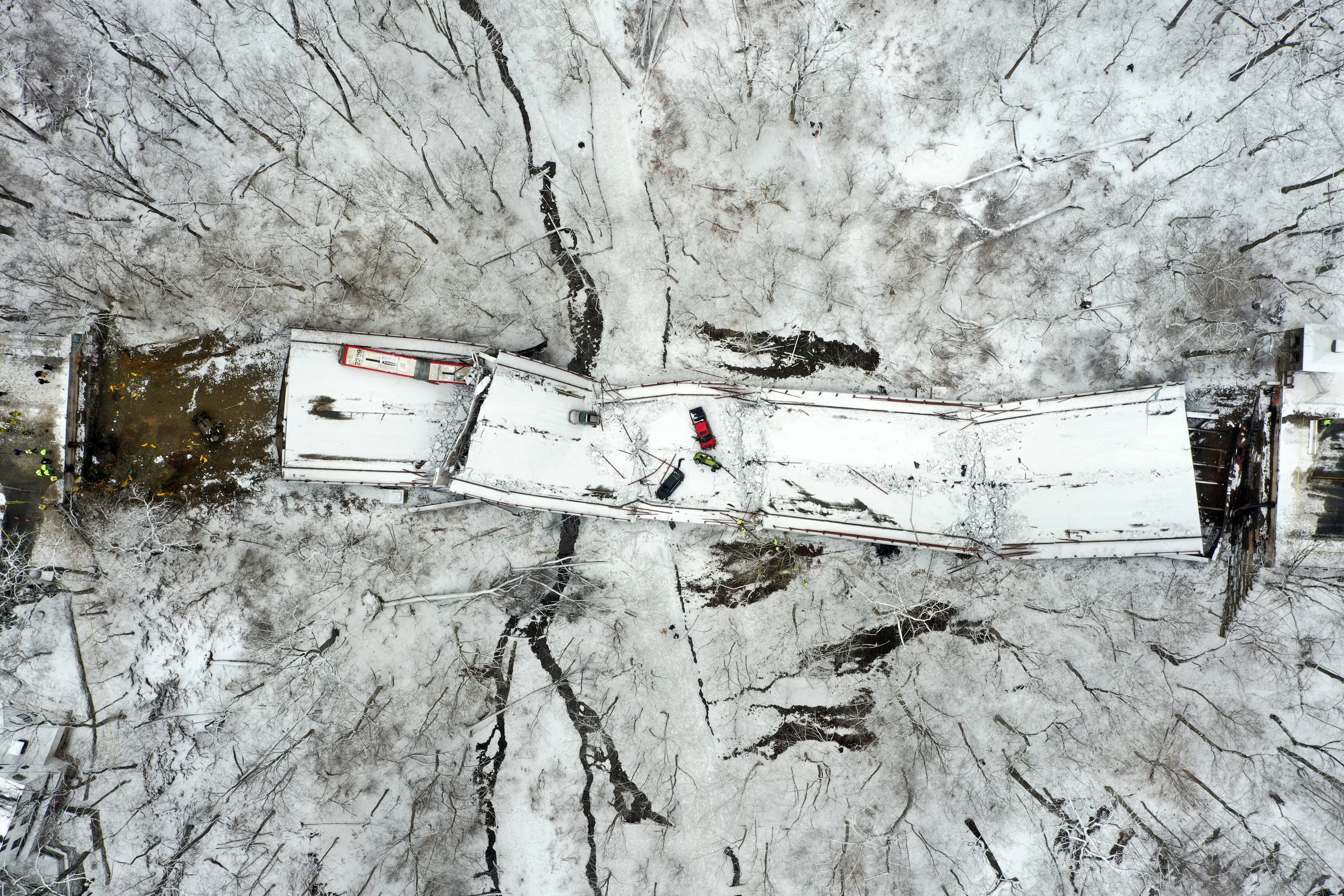 Drone footage shows bridge crumpled in ravine below