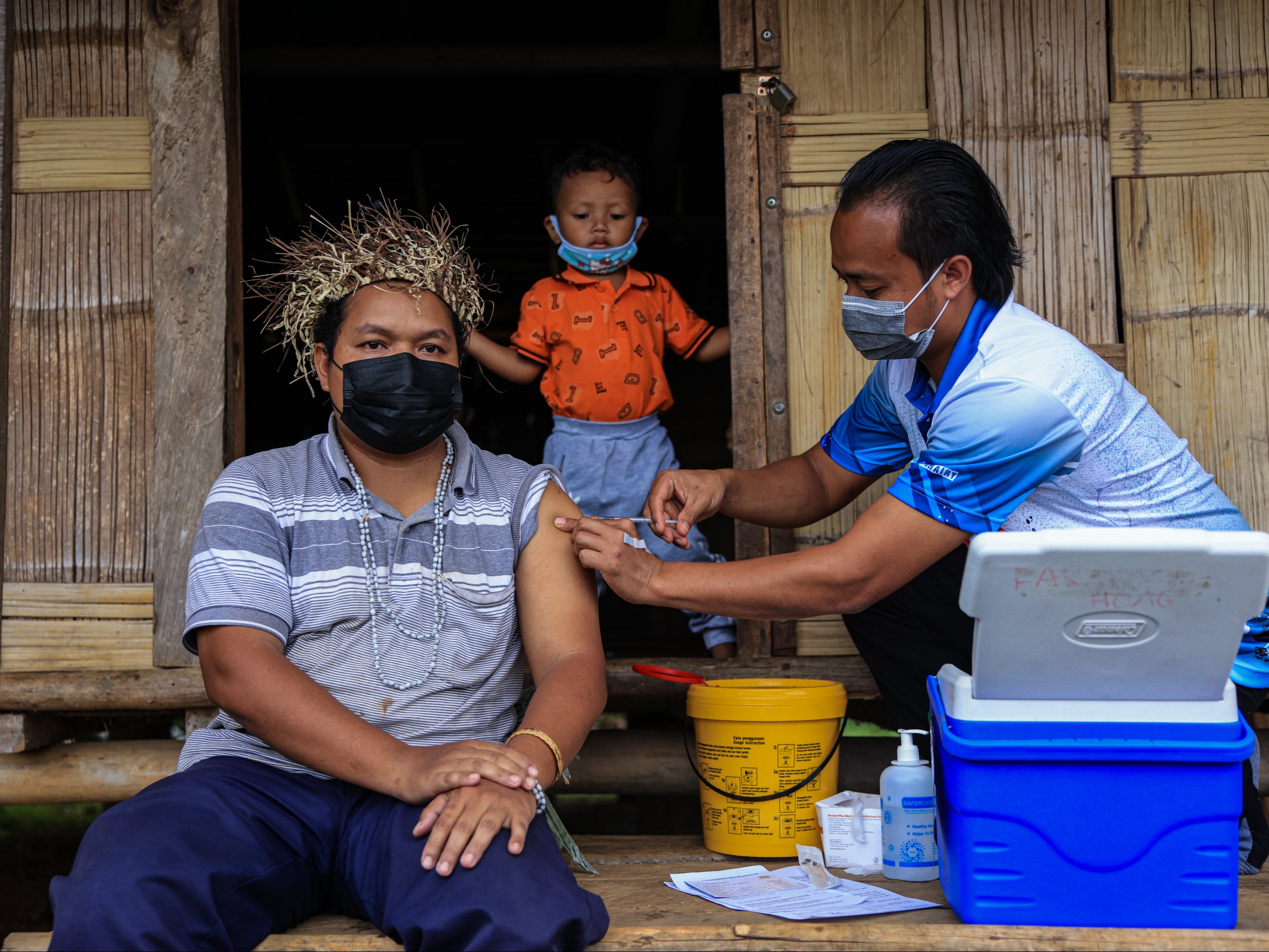 Nur Mohd Safiq receives a dose of the CanSino vaccine in Pos Simpor, a village in Kelantan, Malaysia